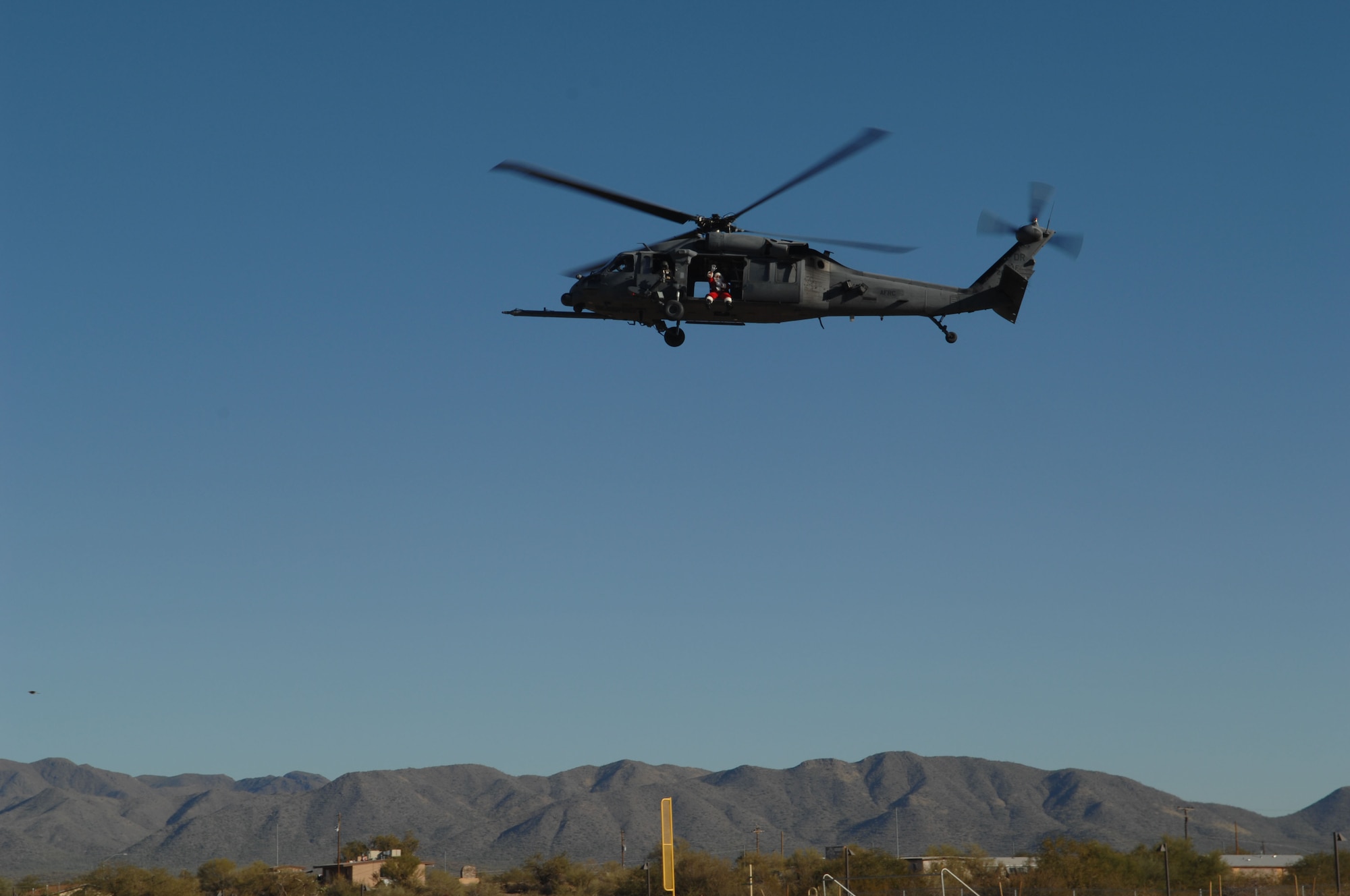 Santa arrives via helicopter to deliver gifts to the children of Indian Oasis Elementary School Dec. 20 as part of the D-M Santa's In Blue program. The presents were donated by the numerous units and organizations on D-M.