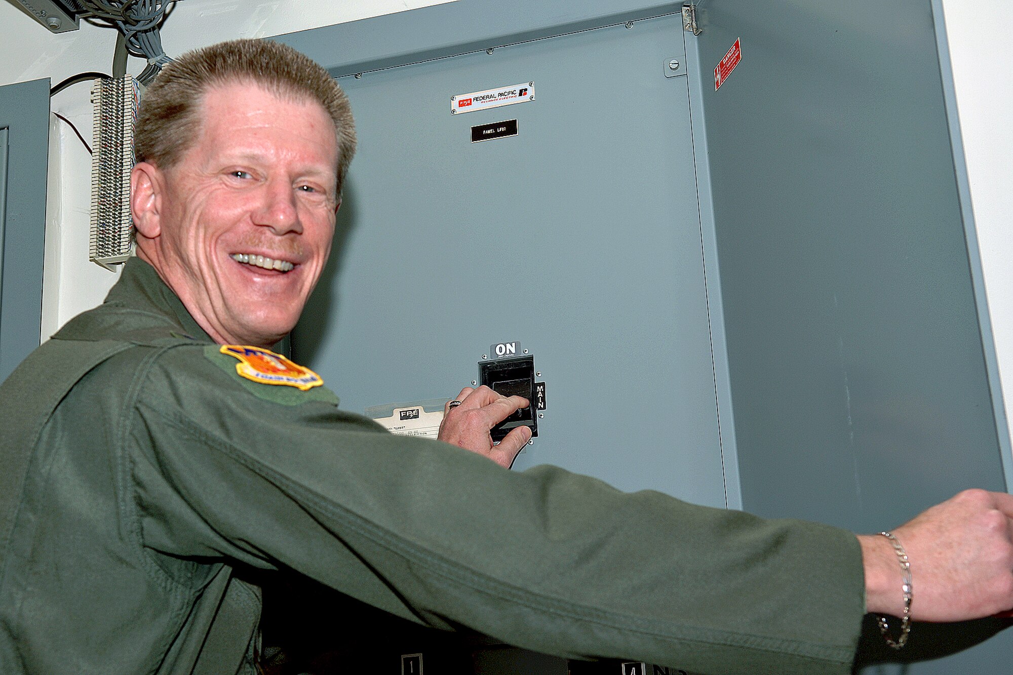DYESS AFB, TX -- Colonel Kevin Jackson, 317th Airlift Group commander, flips a switch to deactivate power to the avionics backshop Dec. 18. The avionics shop will no longer repair avionics equipment in the backshop setting. Instead, they will be relocated to the flightline where they are needed to support the mission. More than 125 man hours were into the flight. According to Maj. Tracey Silfies, 317th Maintenance Squadron commander, "the Air Force is making a step forward in the maintenance world by shifting resourses to the flightline where their experience is needed." (U.S. Air Force Photo by Airman 1st Class Micheal Breaux)