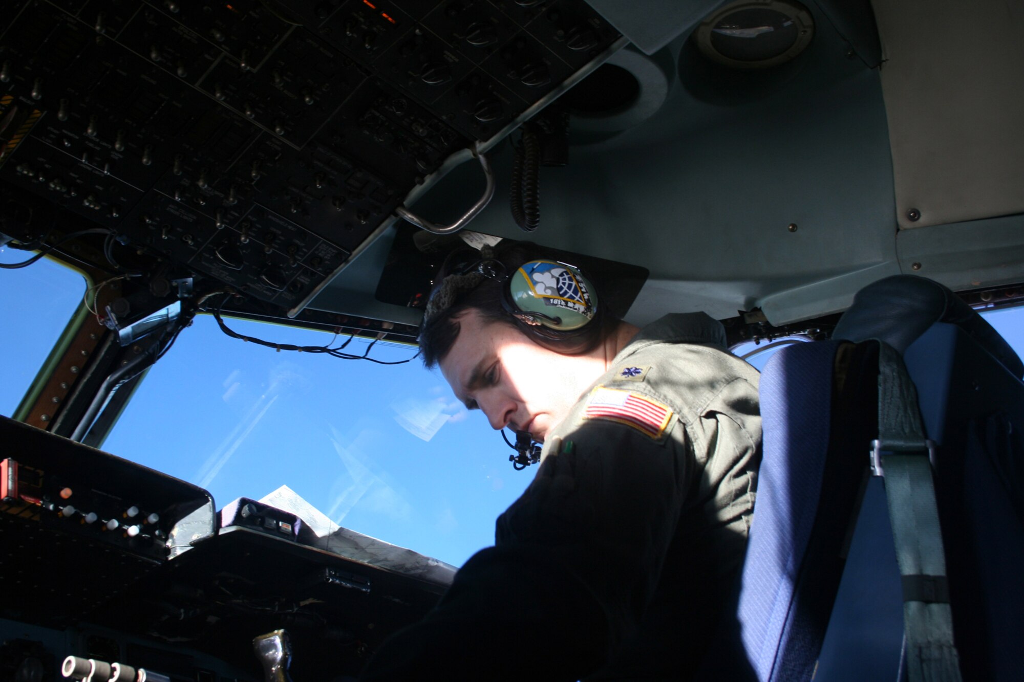 OVER THE ATLANTIC OCEAN --   Co-pilot Lt. Col. Jeffrey Tuner tweaks the radio control to get a better signal. (U.S. Air Force photo/Maj. Ted Theopolos)