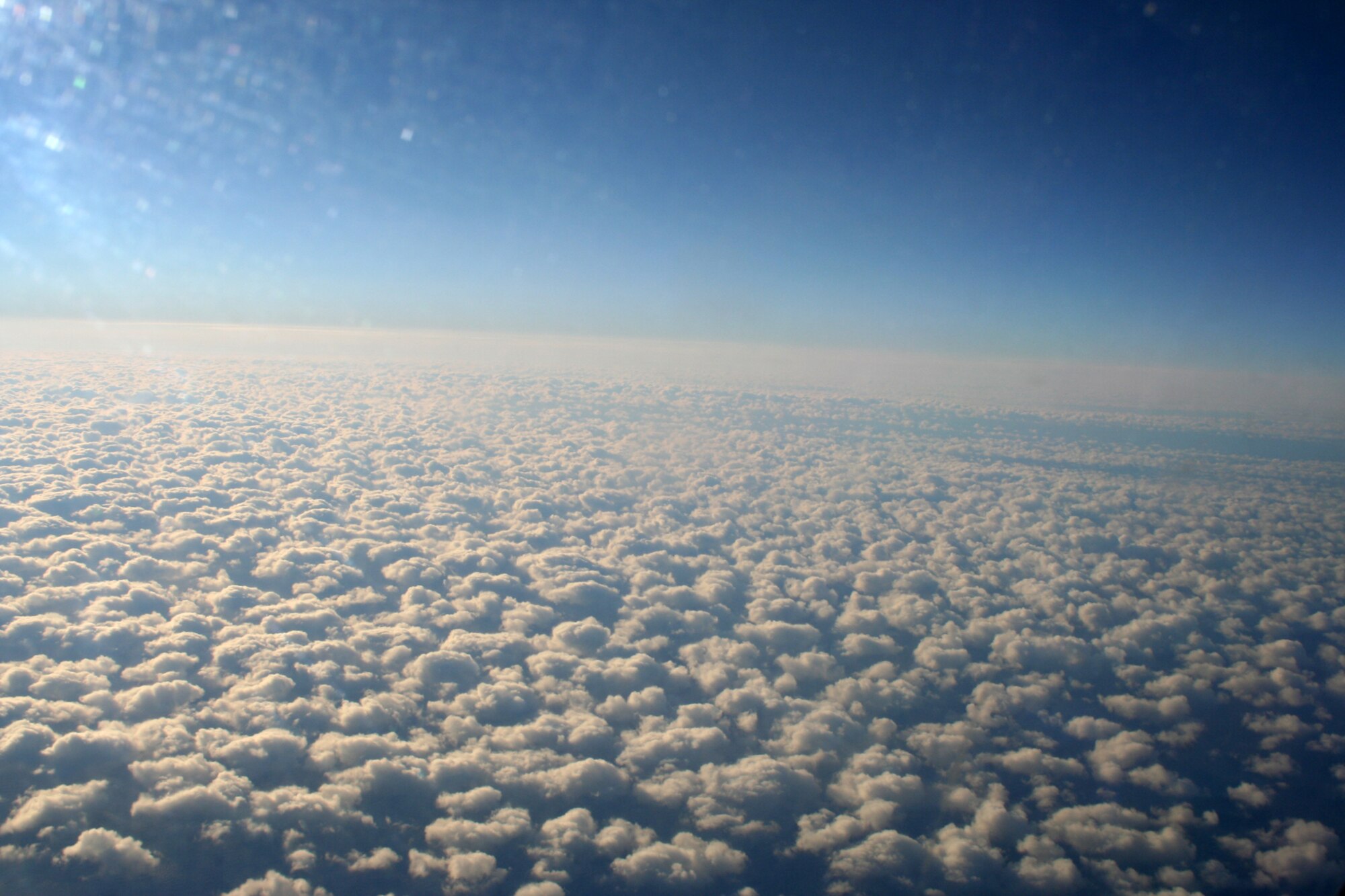 OVER THE ATLANTIC OCEAN --   Looking out the flight deck window of a C-5 at an altitude of 31,000 feet, the clouds look like white cotton balls clumped together. (U.S. Air Force photo/Maj. Ted Theopolos)