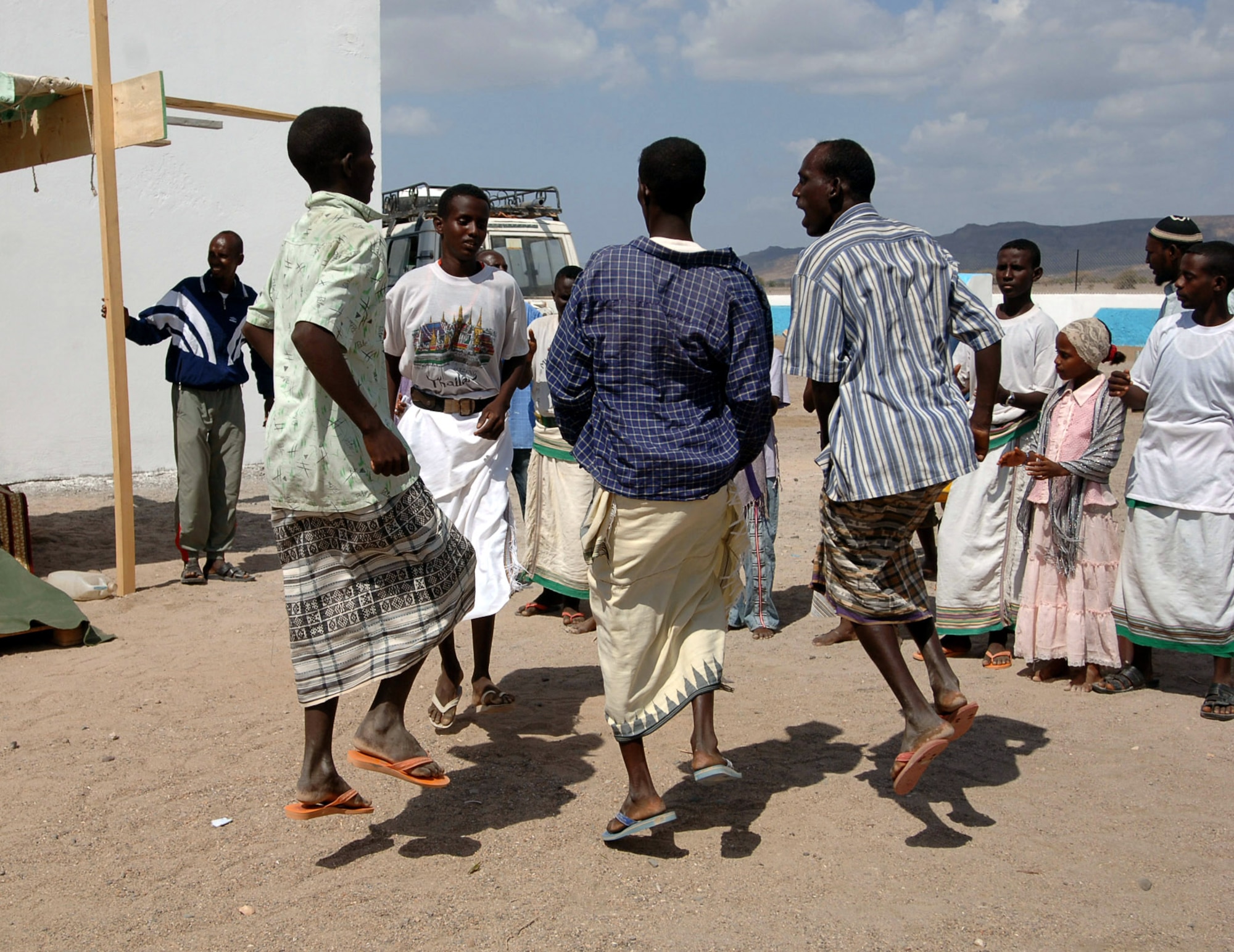 Kouta Bouya villagers put on a traditional dance for the U.S. servicemembers and the U.S. Embassy to Djibouti representative on hand to celebrate the Kouta Bouya Primary School dedication ceremony Dec. 17 in Djibouti. (U.S. Navy photo/Petty Officer 1st Class Mary Popejoy)