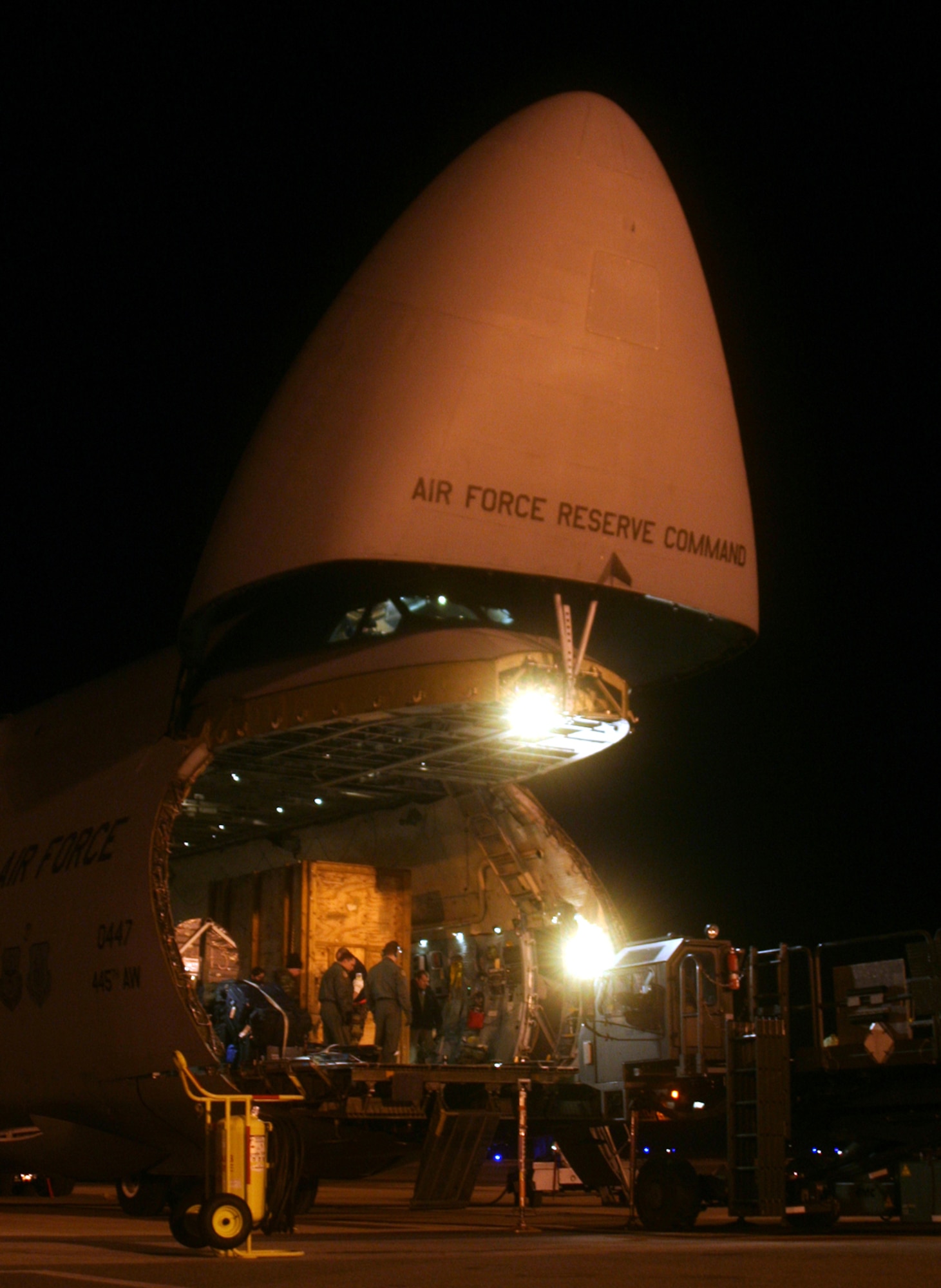 DOVER AIR FORCE BASE, Del --   A 60K-Tunner Material Loader, commonly called a K-loader, pulls forward to load equipment and supplies on a C-5 aircraft preparing to transport 83,954 lbs., to Ramstein Air Base, Germany. (U.S. Air Force photo/Maj. Ted Theopolos)