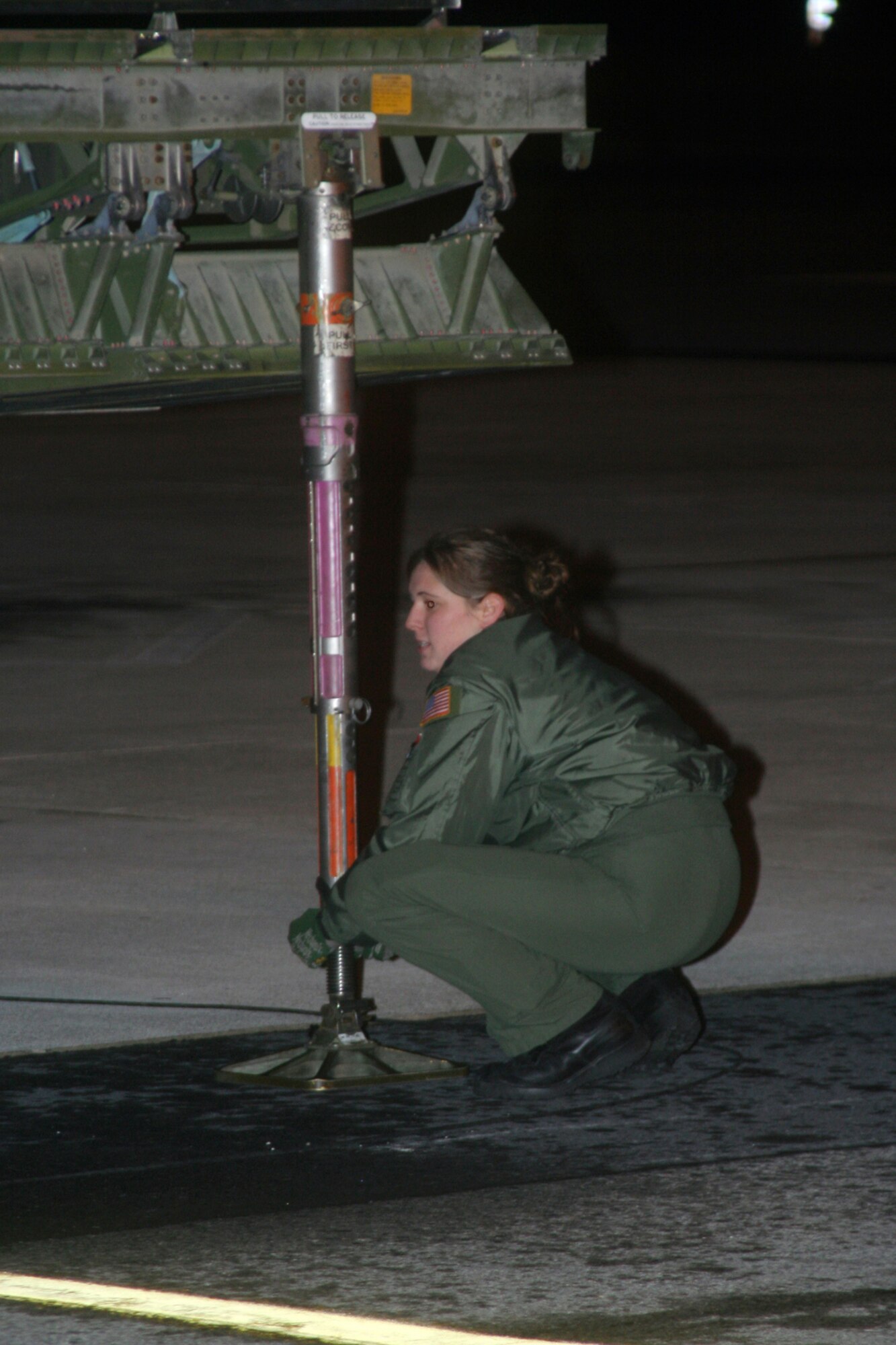 DOVER AIR FORCE BASE, Del --  Loadmaster Senior Airman Danielle Kremer secures a jack to help support the extended floor before heavy equipment was loaded on a C-5 aircrft. (U.S. Air Force photo/Maj. Ted Theopolos)