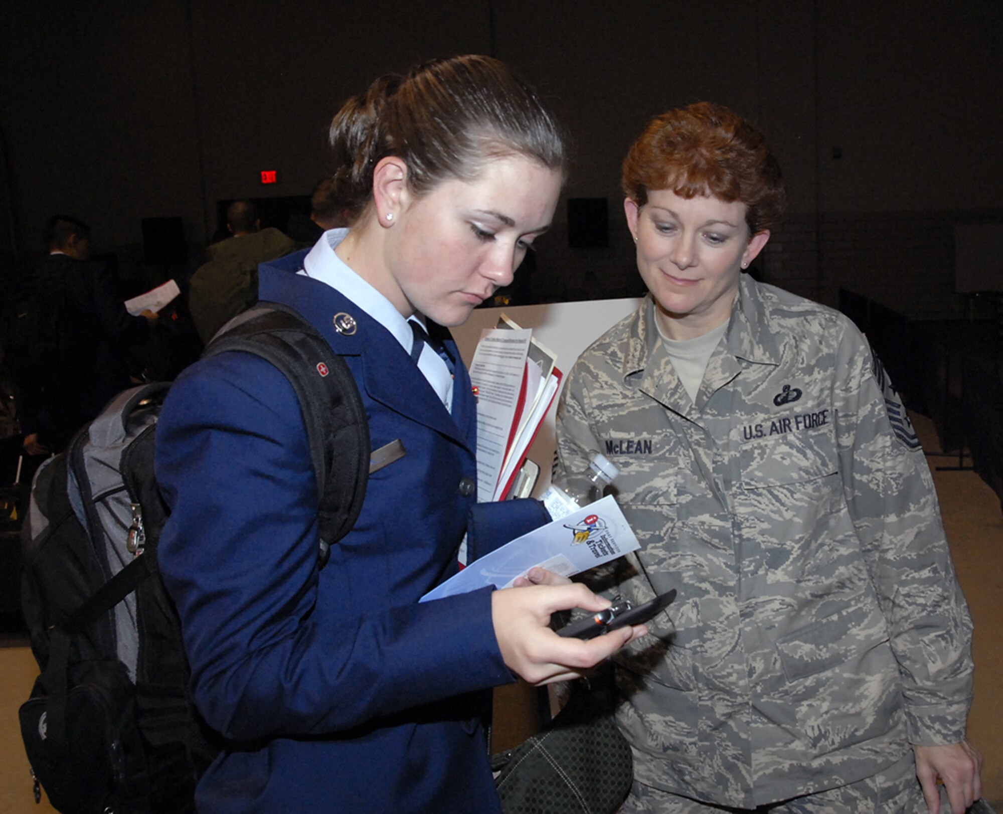 Chief Master Sgt. Jeannie McLean, 82nd Training Wing command chief master sergeant, provides assistance to an Airman in Training Dec. 21 during the annual holiday exodus. More than 2,500 Airmen boarded buses, limousines and shuttles departing for North Texas and Central Oklahoma airports. (U.S. Air Force photo/Sandy Wassenmiller)