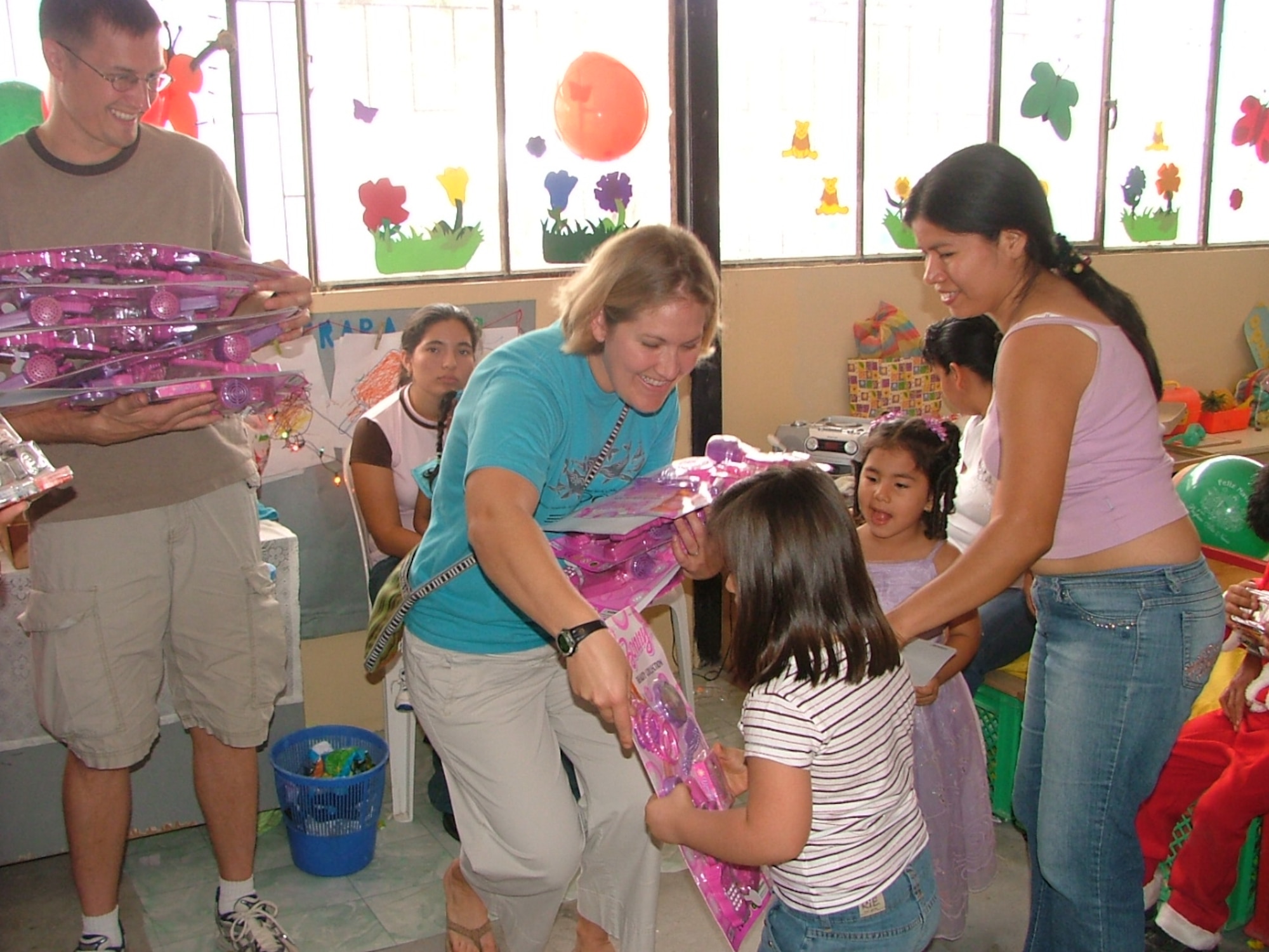 1st Lt. Whitney Lewis and Staff Sgt. Jamie Lewis, who are both deployed to the FOL Manta from Tinker AFB, hand out toys to students at Angelica Flores, which is a school for disabled children in Manta, Ecuador.  The toys were handed out as part of the FOL Manta’s Toys for Tots program.  This year the members of the FOL were able to hand out more than 4500 toys to 20 different local organizations. (U.S. Air Force photo/1st Lt. Malinda Singleton)