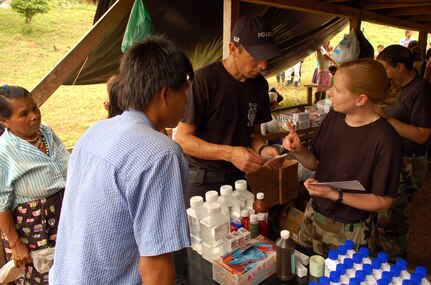 PIEDRA MESA, Costa Rica – Air Force Staff Sgt. Aimee Orndorff, Joint Task Force-Bravo Medical Element, explains medication directions to a Costa Rican translator in the pharmacy of a makeshift clinic here Dec. 18.  JTF-Bravo deployed 28 servicemembers from Soto Cano Air Base, Honduras to Costa Rica, at the invitation of the country’s Ministry of Health, for the first Medical Readiness Training Exercise in more than three years.  (U.S. Air Force photo by Staff Sgt. Austin M. May)