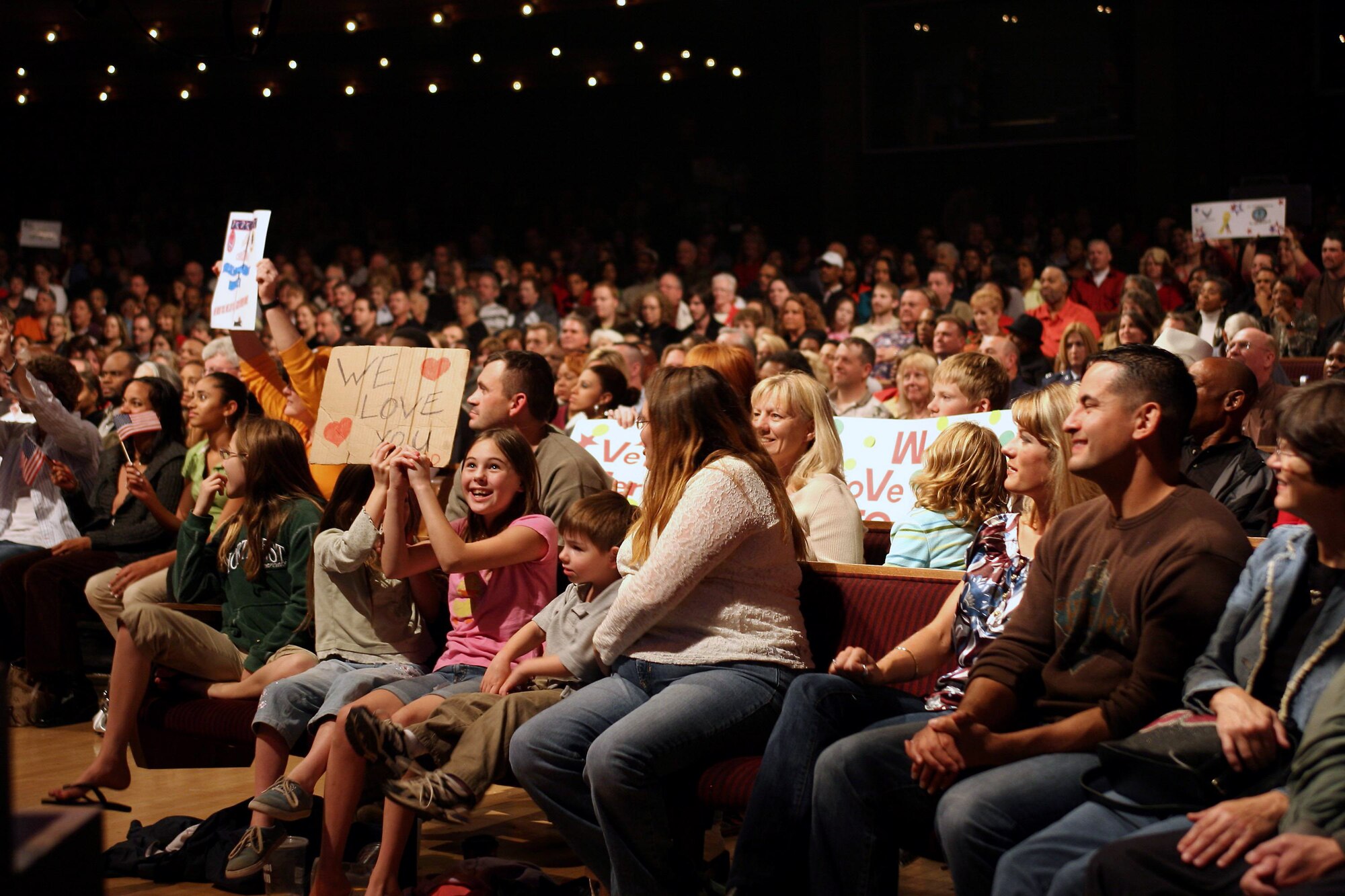 Audience members at this year's Holiday Notes from Home cheer during the show at the Grand Ole Opry in Nashville, Tenn. Holiday Notes from Home is an annual concert recorded for broadcasting to audiences around the world during December. The Band of the Air Force Reserve and the Air Force Strings performed in the show. (U.S. Air Force photo)