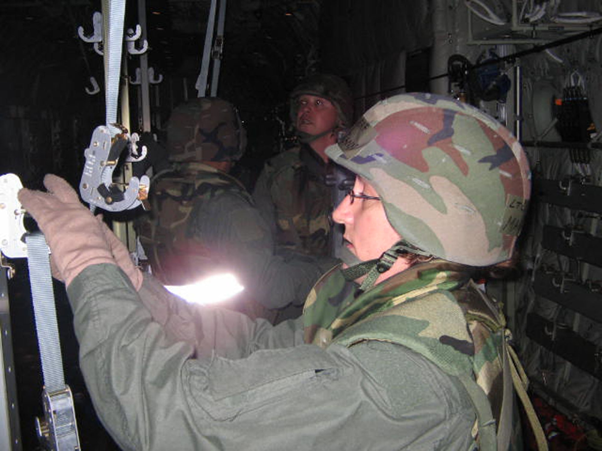 Major Mary McCann, a flight nurse with the 433rd Aeromedical Evacuation Squadron, helps her AE crew ready an aircraft for patient evacuation. The AE team recently showed how well they can perform under varying threat conditions during the Wing Operational Readiness Inspection. (U.S. Air Force Courtesy Photo)