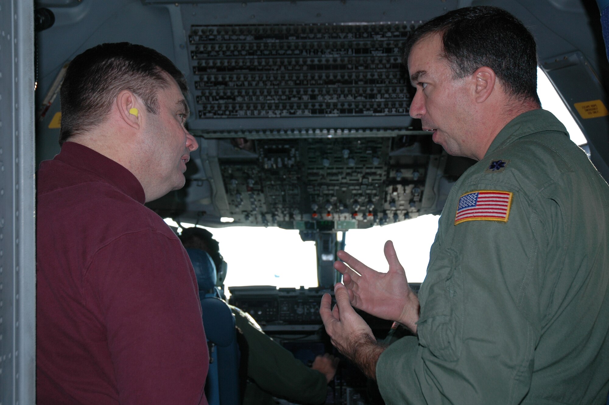 Lt. Col. John Russi, 315th Operations Support Squadron, describes the 15-ship formation from the cockpit of a C-17 to a Charleston civic leader Dec. 20. As part of the flight, 35 local civic leaders and employers of Reservists rode along to see the capabilities of C-17s, maintainers and aircrew members. (Photo by Staff Sgt. Scott Mathews, USAFR)
