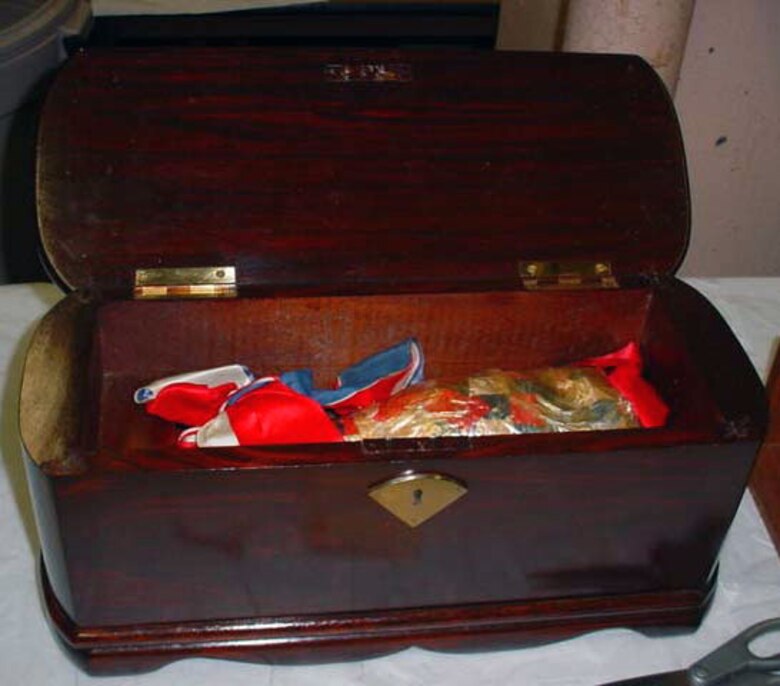 This champagne bottle (in pieces inside the case) was used by Adelaide Rickenbacker, the wife of Capt. Eddie Rickenbacker, to launch USS Mazama (AE-9) on Aug. 15, 1943. (U.S. Air Force photo)