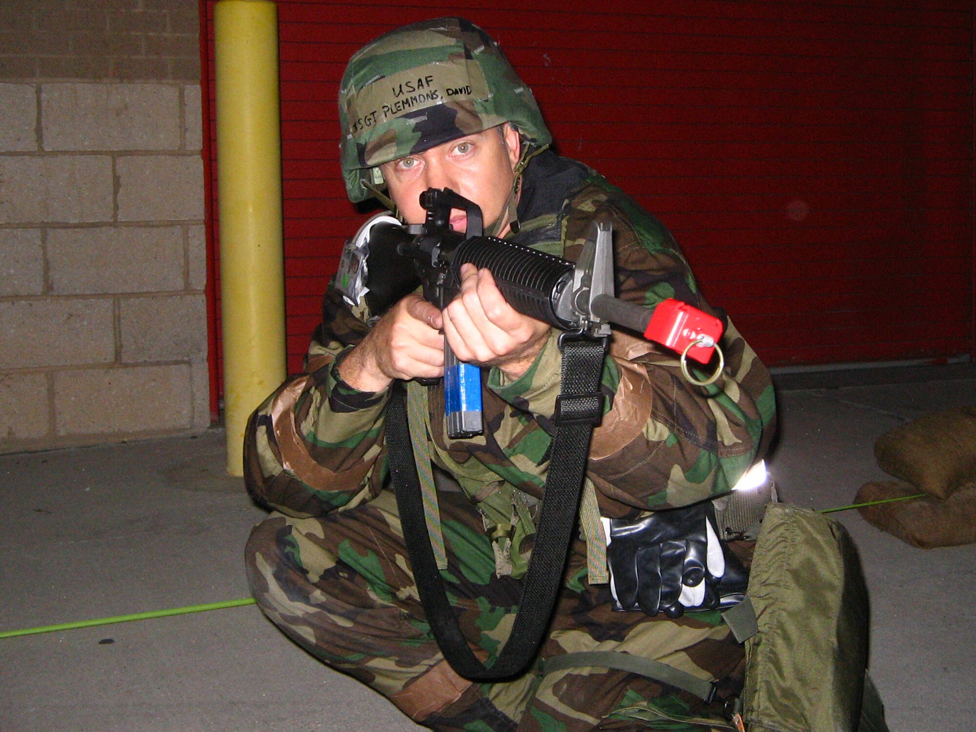 Staff Sgt. David Plemmons, an aircraft electrician with the 433rd Aircraft Maintenance Squadron, takes up a protective posture inside a simulated bunker during the recent Operational Readiness Inspection. The ORI showed that the Airmen of the Alamo Wing are war ready. (U.S. Air Force Courtesy Photo)  