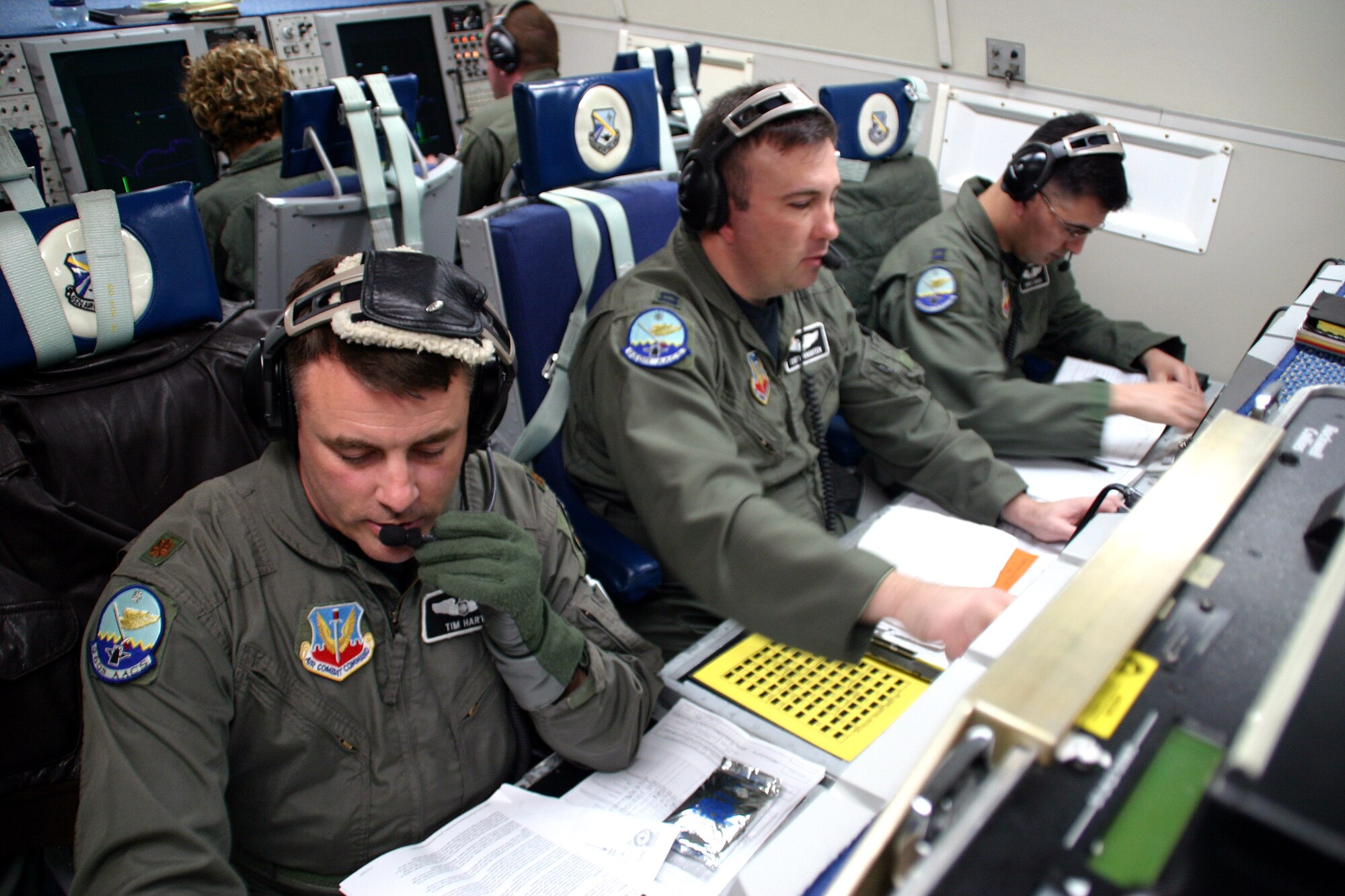 Maj. Tim Hart, Capt. Curtis Knighten and Capt. James Garza conduct air surveillance and command and control operations from an E-3 Sentry. The members of the 960th Airborne Air Control Squadron are preparing for a Christmas Eve Santa tracking mission. Airborne warning and control systems crews will provide additional surveillance as part of Operation Just Claus. (U.S. Air Force photo/Staff Sgt. Stacy Fowler)