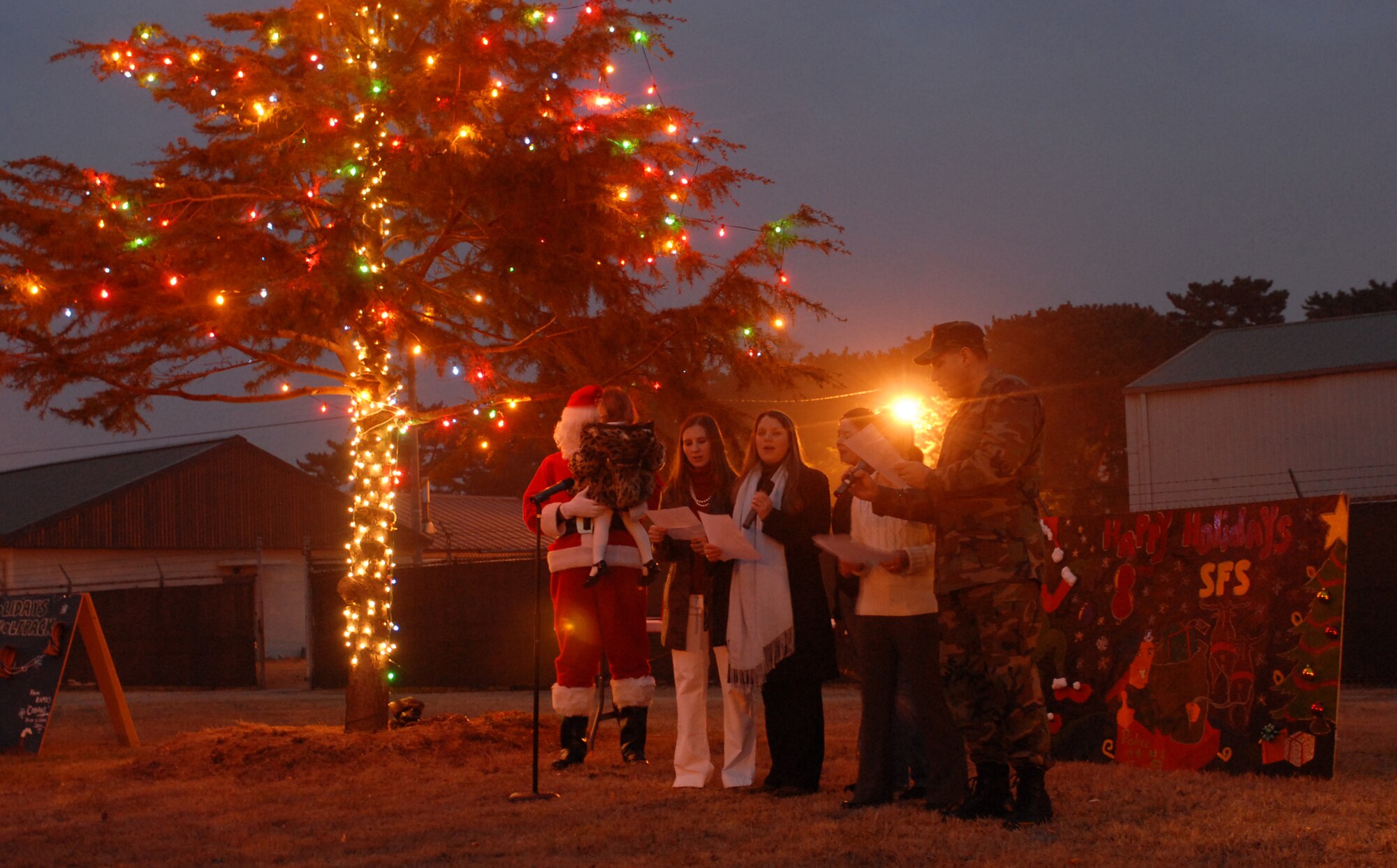 KUNSAN AIR BASE, South Korea -- Members of the 8th Fighter Wing gather to sing Christmas songs during the Holiday Lighting Ceremony here Dec. 21. The lighting ceremony is an annual event held to help boost morale during the holiday season. (U.S. Air Force photo/Senior Airman Giang Nguyen)