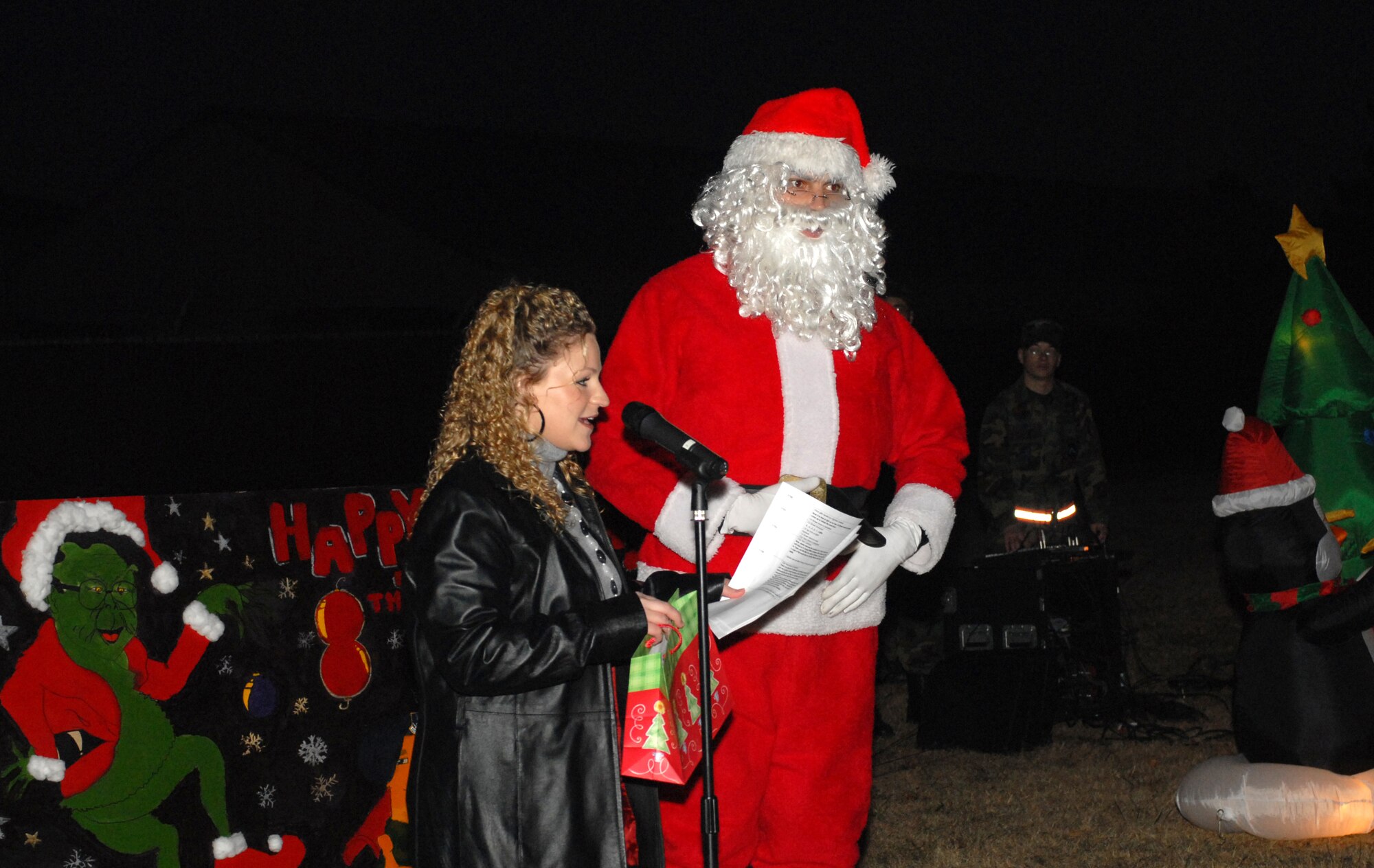 KUNSAN AIR BASE, South Korea -- Staff Sergeant Amanda Hass, 8th Services Squadron, and Santa welcome 8th Fighter Wing Airmen to the Holiday Lighting ceremony here Dec. 21. The lighting ceremony is an annual event held to help boost morale during the holiday season. (U.S. Air Force photo/Senior Airman Giang Nguyen)
