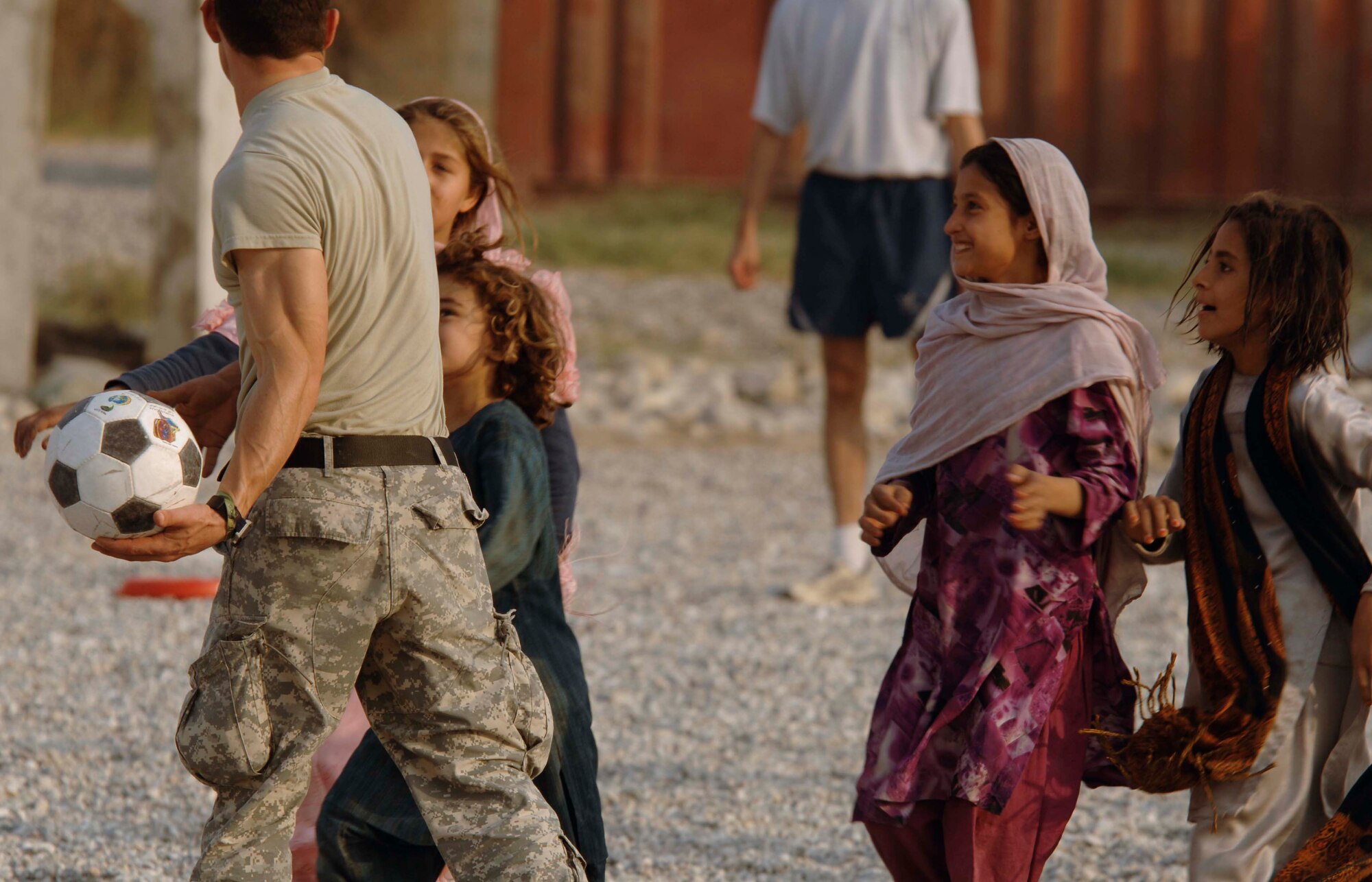 NANGARHAR PROVINCE, Afghanistan - Army and Air Force members from the Nangarhar Provincial Reconstruction Team and children from a local village play soccer together at the PRT’s Forward Operating Base in Jalalabad, Nov. 9, 2007. The Nangarhar PRT is a joint team of Airman, Soldiers, and representatives from the U.S. Department of State, U.S. Agency for International Development and the U.S. Department of Agriculture.  The team is responsible for helping the Government of the Islamic Republic of Afghanistan improve security, governance and promote reconstruction in Nangarhar Province.  The PRT assesses community needs and then builds schools, government centers, roads, medical capability and basic infrastructure throughout the province. (U.S. Air Force photo by Staff Sgt. Joshua T. Jasper) 