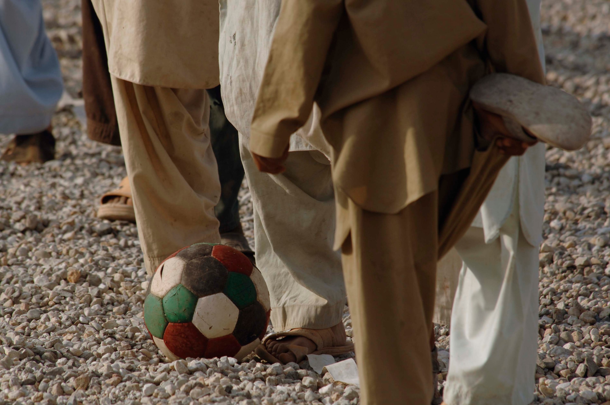 NANGARHAR PROVINCE, Afghanistan - Army and Air Force members from the Nangarhar Provincial Reconstruction Team and children from a local village stretch before they play soccer together at the PRT’s Forward Operating Base in Jalalabad, Nov. 9, 2007. The Nangarhar PRT is a joint team of Airman, Soldiers, and representatives from the U.S. Department of State, U.S. Agency for International Development and the U.S. Department of Agriculture.  The team is responsible for helping the Government of the Islamic Republic of Afghanistan improve security, governance and promote reconstruction in Nangarhar Province.  The PRT assesses community needs and then builds schools, government centers, roads, medical capability and basic infrastructure throughout the province. (U.S. Air Force photo by Staff Sgt. Joshua T. Jasper)  