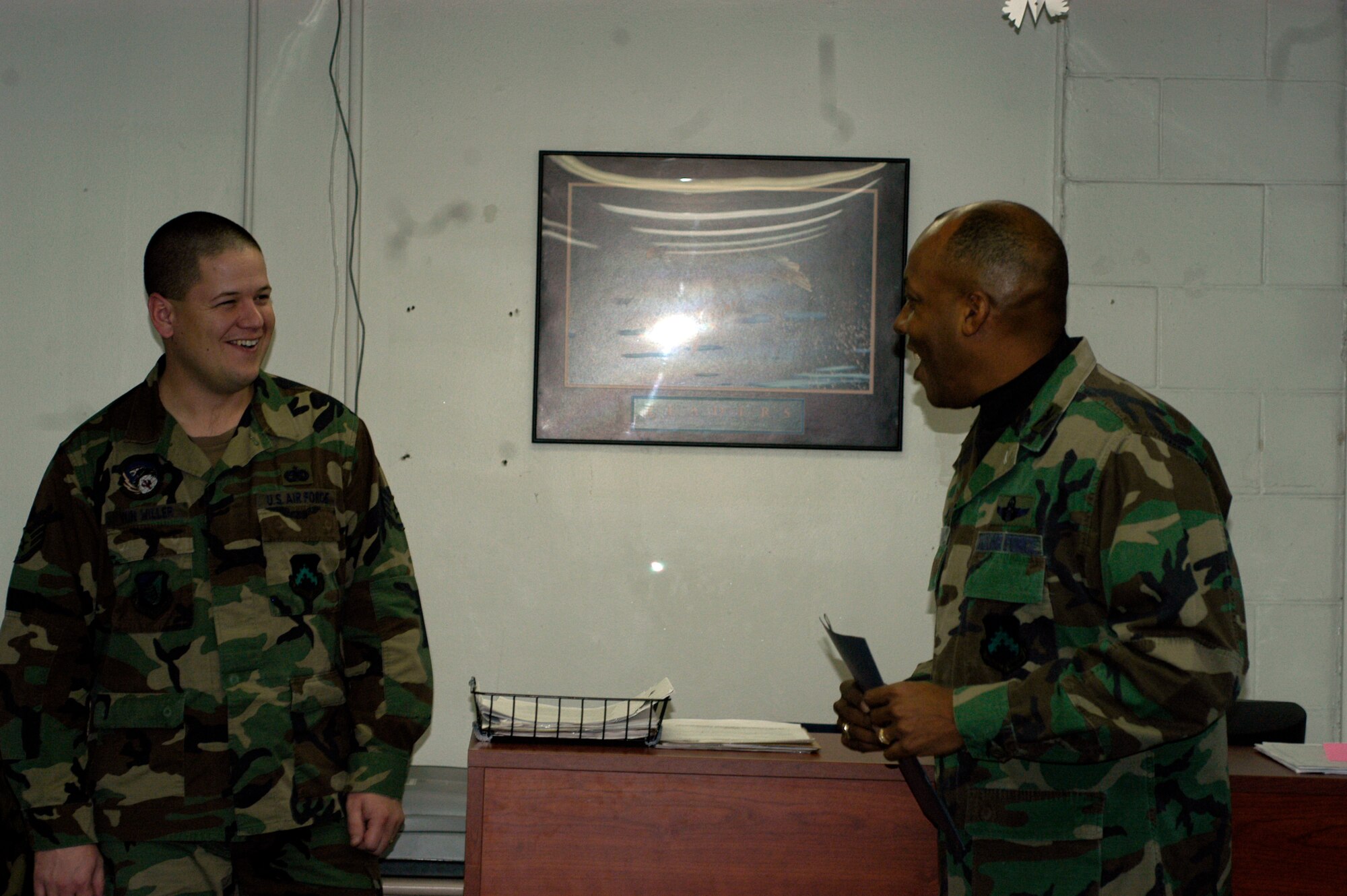 KUNSAN AIR BASE, South Korea --  Colonel CQ "Wolf" Brown, 8th Fighter Wing commander, congratulates Staff Sgt. Brandon Von Willer, 8th Logistics Readiness Squadron assistant NCO in charge of personal property, here Dec. 14. Sergeant Von Willer was recognized as the wing's Pride of the Pack for the week of Dec. 10. (U.S. Air Force photo/Staff Sgt. Alice Moore)