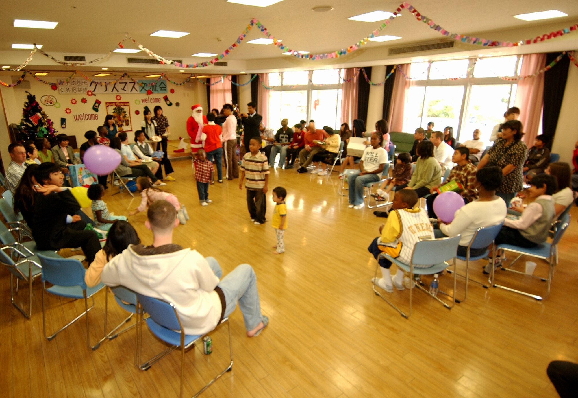 Airmen, Marines and military members visit Asahi Ryo, a special needs home for the mentally challenged located in Haebaru town, for a Christmas friendship exchange Dec. 16, Okinawa, Japan. The volunteers participated in games with the children and provided desserts along with presenting Christmas gifts. 
(U.S. Air Force photo/Tech. Sgt. Rey Ramon)
