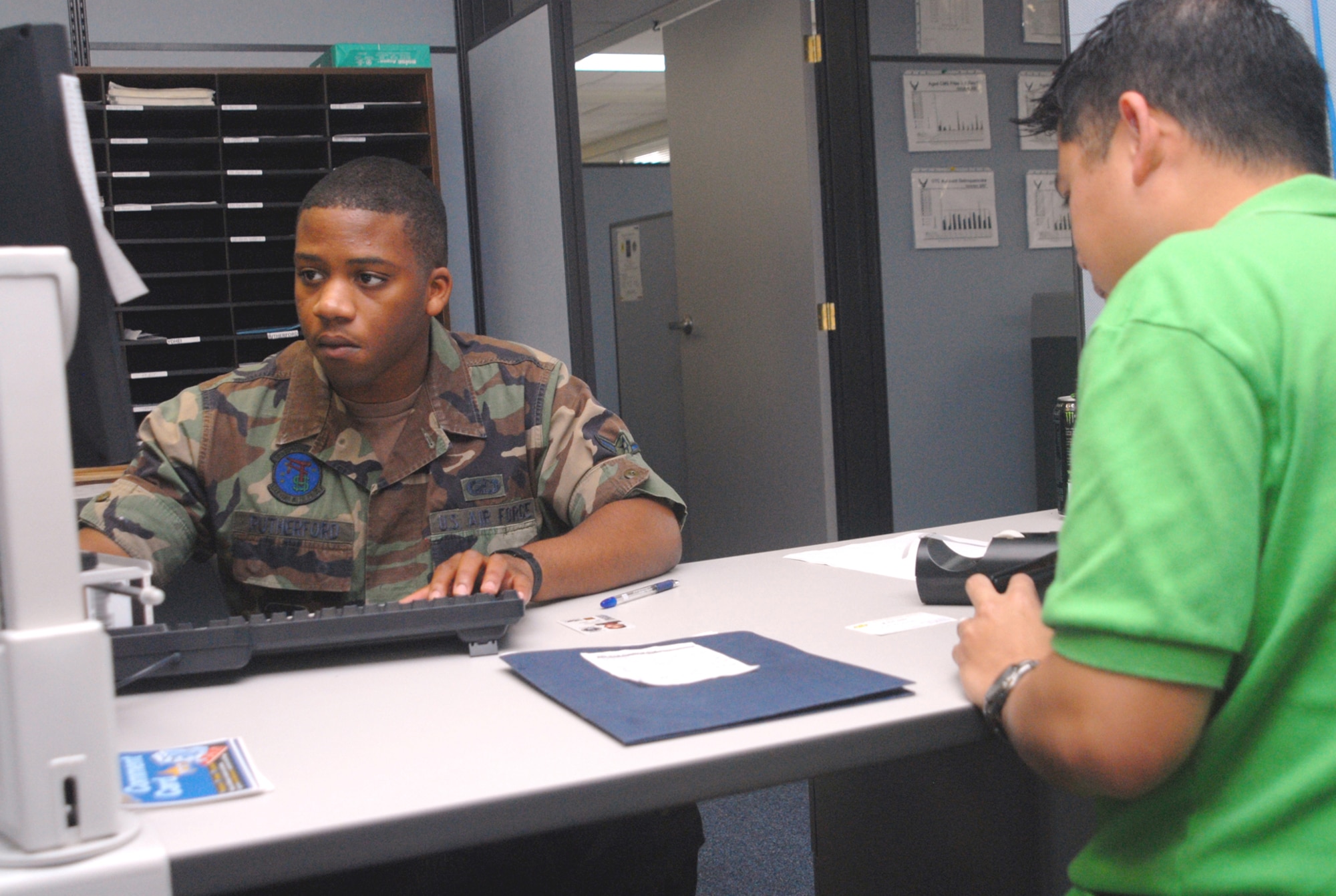 Airman Thomas Rutherford, 18th Comptroller Squadron, helps Staff Sgt. Antonio Garcia from the 320th Special Tactics Squadron with finance paperwork Dec. 19, Kadena Air Base, Japan.  The 18th CPTS financial customer service center sees roughly 3,200 personnel a month.
(U.S. Air Force/Staff Sgt. Christopher A. Marasky)