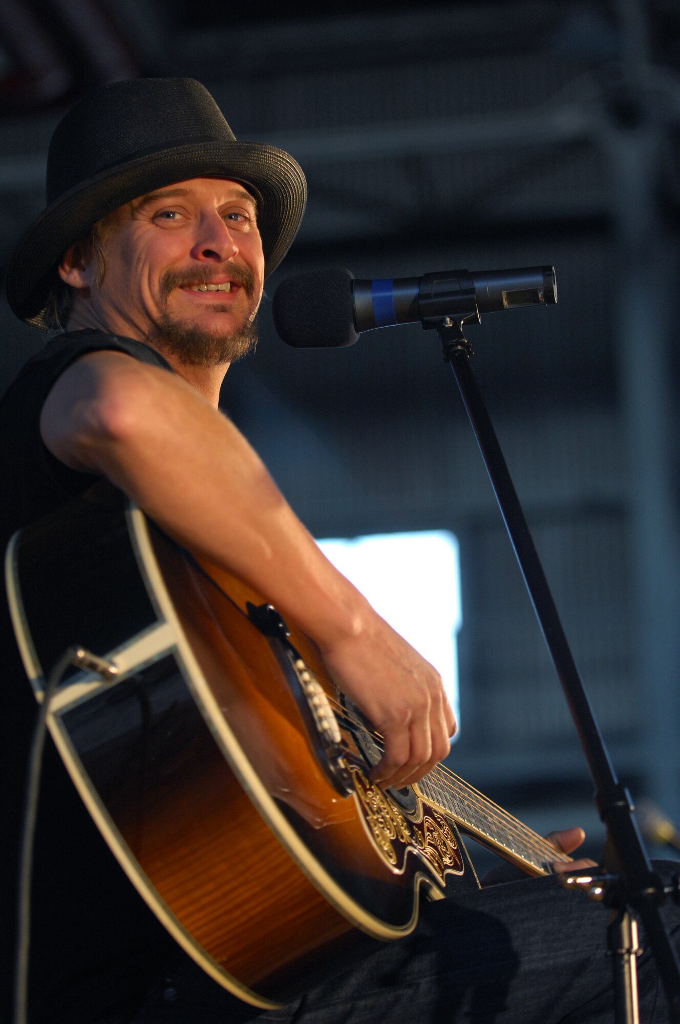 AVIANO AIR BASE, Italy--  "Rock Star" Kid Rock smiles big for the camera while performing as part of a USO holiday show held for the Aviano community, Dec. 22, 2007.  Navy Adm. Michael G. Mullen, chairman of the Joint Chiefs of Staff, arrived in Aviano early Saturday afternoon from down range, bringing entertainers and celebrities Robin Williams, Lewis Black, Kid Rock, Lance Armstrong, Rachel Smith, the reigning Miss USA, and Ronan Tynan an Irish Tennor on the Chairman's United Service Organizations Holiday tour.  (U.S. Air Force photo/Staff Sgt. Michael R. Holzworth) 