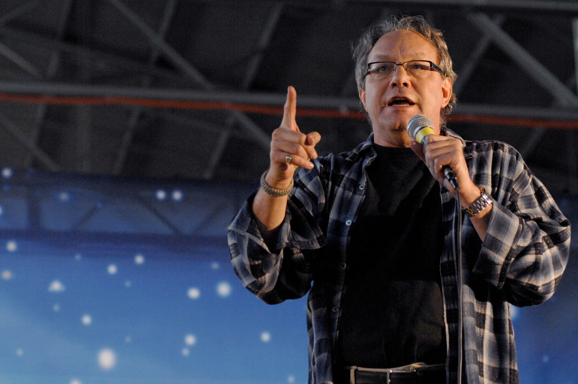 AVIANO AIR BASE, Italy-- Comedian Lewis Black performs as part of a USO holiday show held for the Aviano community, Dec. 22, 2007.  Navy Adm. Michael G. Mullen, chairman of the Joint Chiefs of Staff, arrived in Aviano early Saturday afternoon from down range, bringing entertainers and celebrities Robin Williams, Lewis Black, Kid Rock, Lance Armstrong, Rachel Smith, the reigning Miss USA, and Ronan Tynan an Irish Tennor on the Chairman's United Service Organizations Holiday tour.   (U.S. Air Force photo/Airman 1st Class Tabitha M. Mans) 