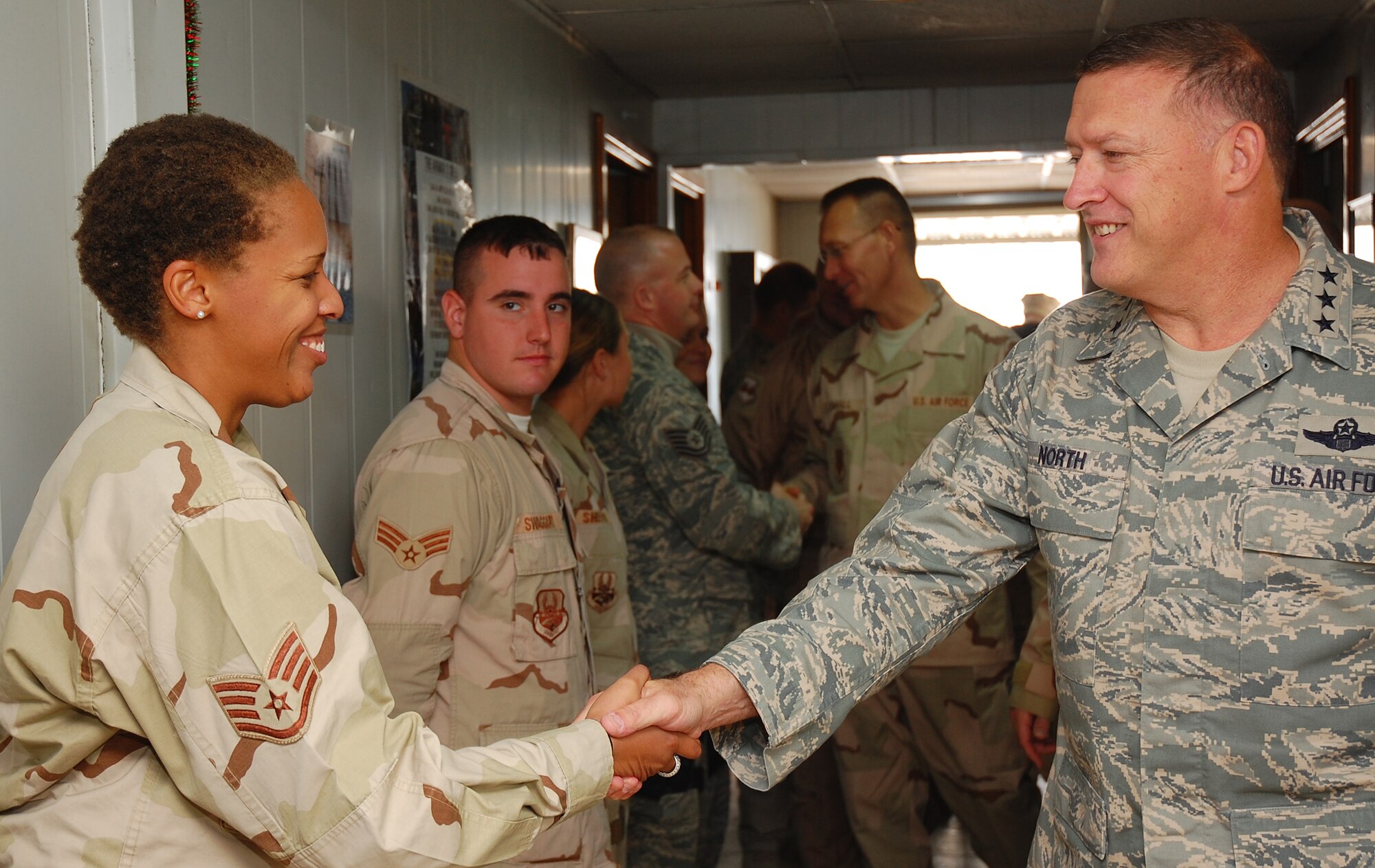 SOUTHWEST ASIA -- Lt. Gen. Gary North greets Staff Sgt. Carla Thornton and other members of the 387th Expeditionary Security Forces Squadron Dec. 22 here. General North, 9th Air Force and U.S. Central Command Air Forces commander, stopped by to formally open a new dining facility and spoke with Airmen while visiting the 387th Air Expeditionary Group.  (U.S. Air Force photo by Staff Sgt. Tia Schroeder)  