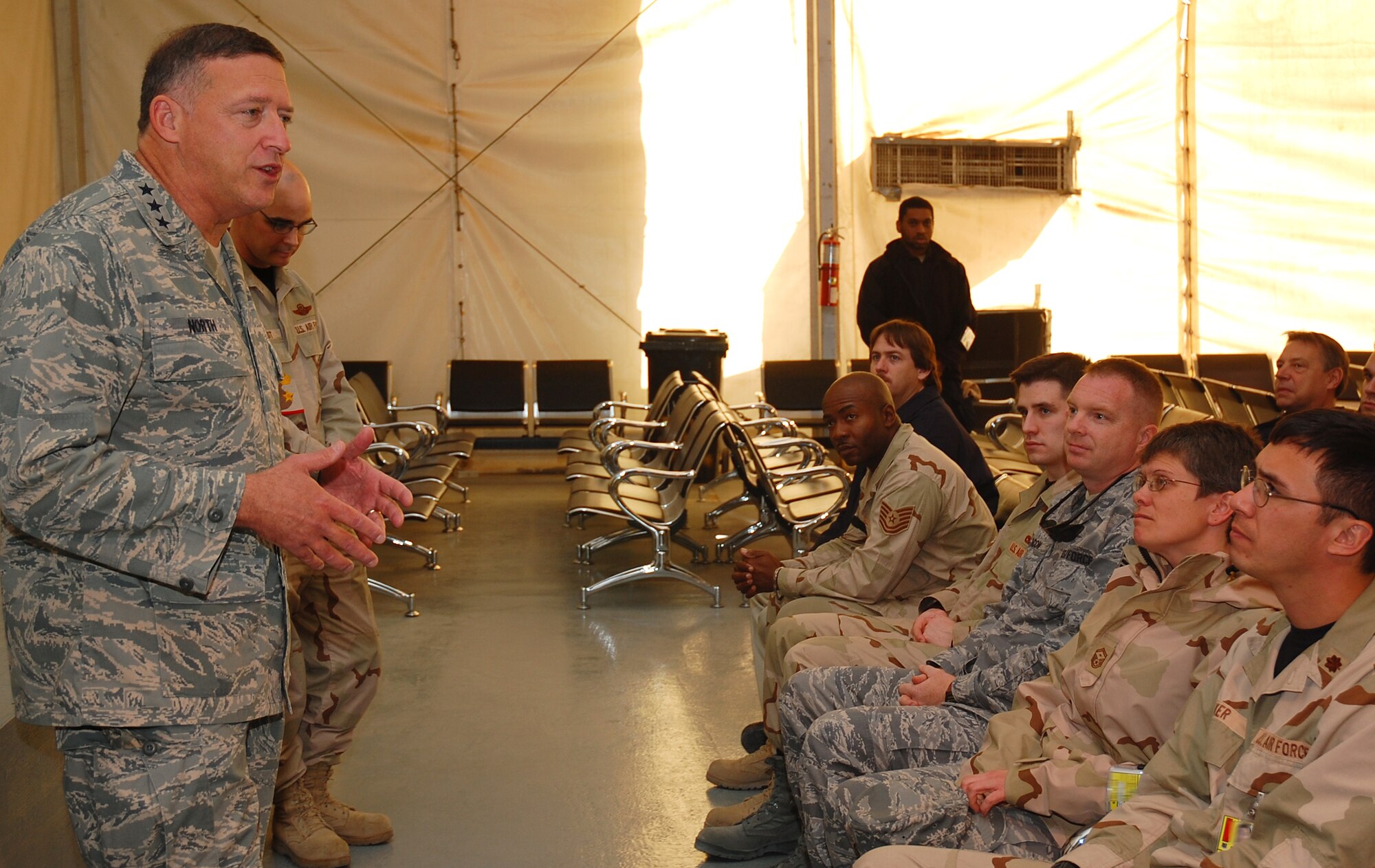 SOUTHWEST ASIA -- Lt. Gen. Gary North visits with members of the 5th Expeditionary Air Mobility Squadron Dec. 22 here.  General North, 9th Air Force and U.S. Central Command Air Forces commander, stopped by to formally open a new dining facility and spoke with Airmen.  (U.S. Air Force photo by Staff Sgt. Tia Schroeder)  