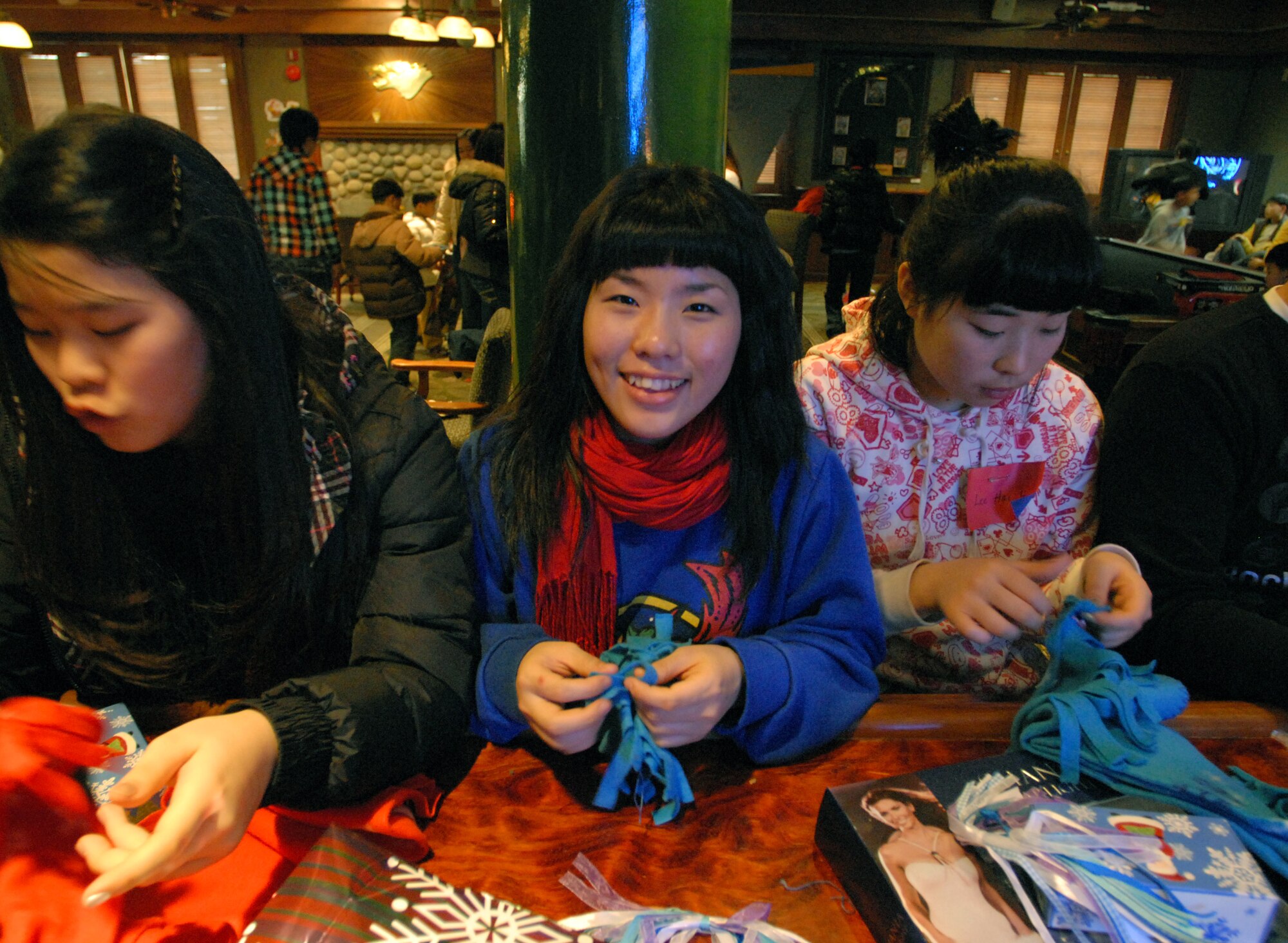 KUNSAN AIR BASE -- Children from the AeYuke orphanage work on a crafts project
during a visit here Dec. 22.  Airmen from the 35th Fighter Squadron spent the afternoon with more than 65 children from a local orphanage touring an F-16 Fighting Falcon and flight simulator, handing out gifts, and playing.  The visit is part of the Good Neighbor Program which helps strengthen relations between Kunsan and the Korean community.  (U.S. Air Force photo/Senior Airman Steven R. Doty)