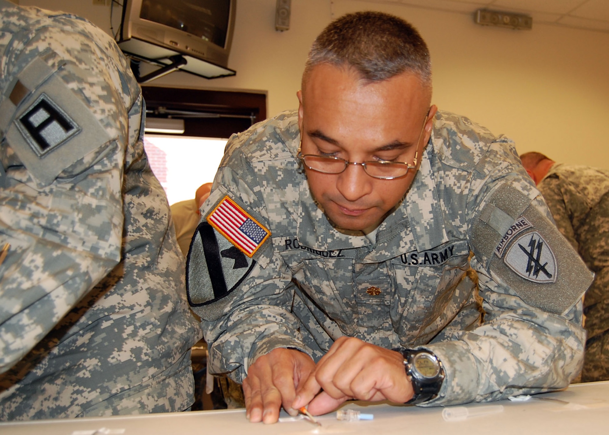 FORT BRAGG, N.C. -- Army Maj. Jesus Rodriguez, deployed from the 451st Civil Affairs Battalion out of Pasadena, Texas, practices inserting an 18 gauge needle and IV catheter into surgical tubing designed to help students approximate what the real thing feels like before practicing on who may end up as less than forgiving fellow service members. The major will serve as Team Paktia’s Executive Officer and lead the Civil/Military Operations Center. (U.S. Air Force photo/Capt. Ken Hall)