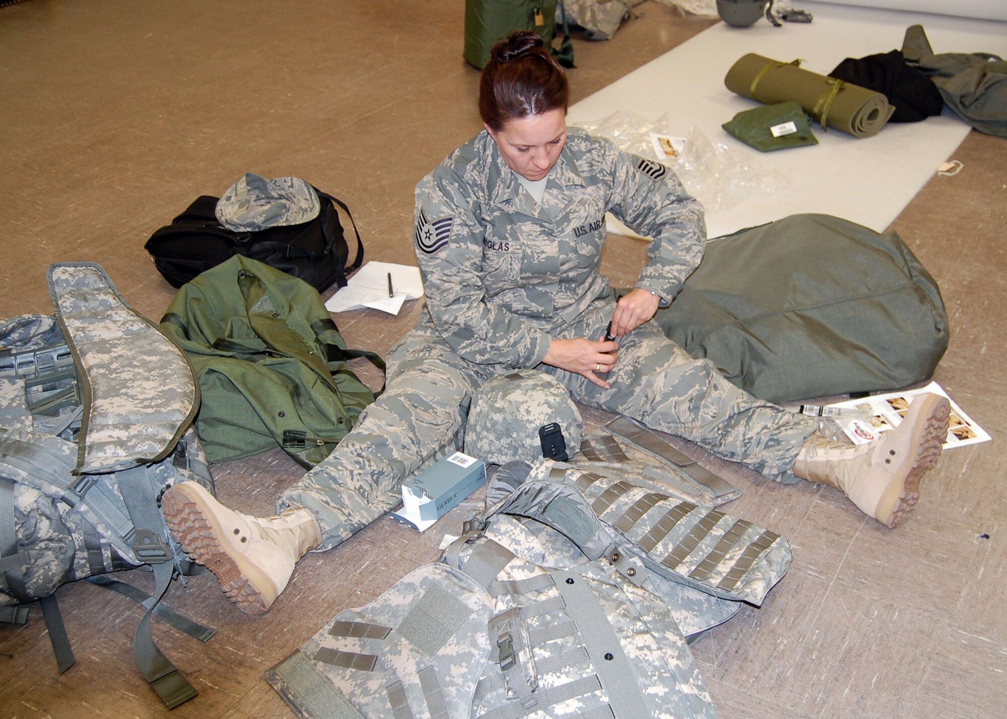 FORT BRAGG, N.C. -- Air Force Tech. Sgt. Hattie Douglas, Team Paktia personnelist, gets her combat equipment together for storing over the Christmas holiday period and break in pre-deployment combat skills training for her upcoming year in Afghanistan working provincial reconstruction. Sergeant Douglas deployed from the University of Arkansas where she works as the noncommissioned officer in charge at the Air Force Reserve Officer Training Corps detachment.  (U.S. Air Force photo/Capt. Ken Hall)