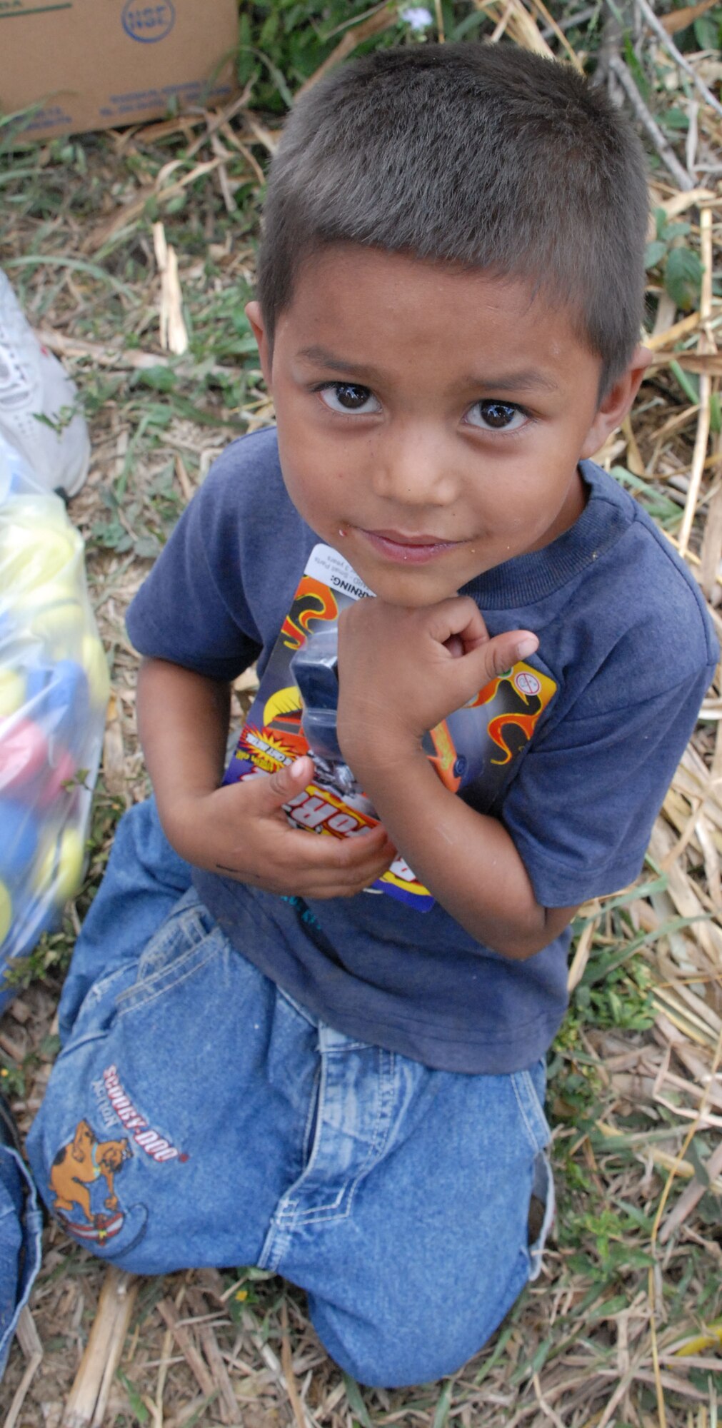 COMAYAGUA, Honduras - A young Honduran boy from a nearby village clutches his new toys he received from American Soldiers, Sailors and Airmen here Dec. 23.  A toy drive was organized by the Joint Task Force-Bravo Chapel and the gifts were donated by the families of servicemembers stationed at Soto Cano Air Base, Honduras.  (U.S. Air Force photo by Tech. Sgt. Sonny Cohrs) 