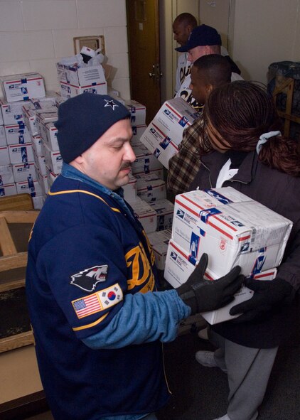 KUNSAN AIR BASE, South Korea -- Chief master sergeants and first sergeants load boxes of Christmas stockings here Dec. 24.  Approximately 3,000 stockings were sent by the Westminster Presbyterian Church and other organizations in Lubbock, Texas for Airmen and Soldiers stationed here.  (U.S. Air Force Photo/Master Sgt Jack Braden)