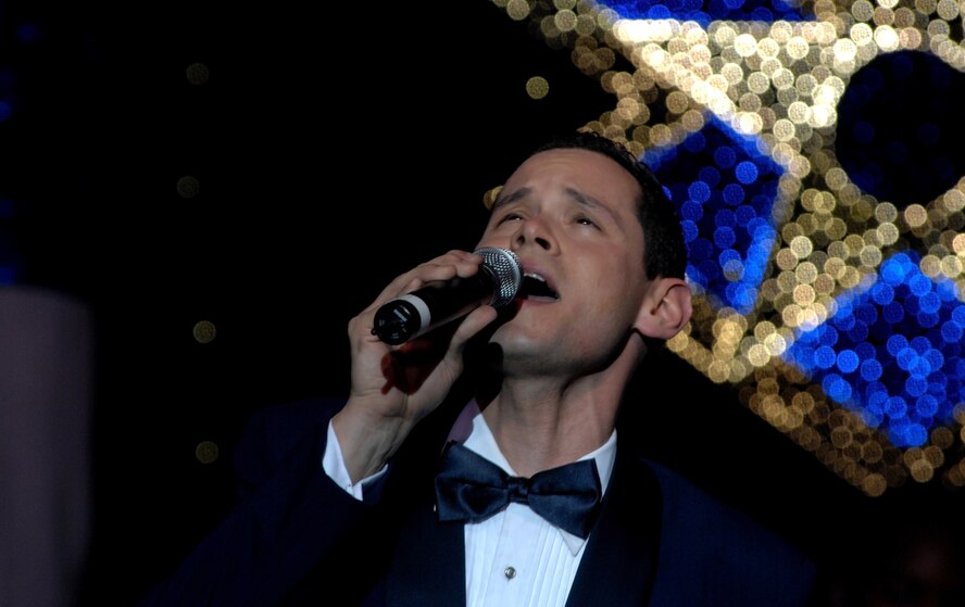 KUNSAN AIR BASE, South Korea -- Staff Sgt. Daniel Rutherford, Tops In Blue vocalist, sings a song during a performance here Dec 23.  The Tops In Blue 2007 tour commemorates the 60th Anniversary of the Air Force and is entitled The Fly By. They performed hits from each decade from 1947-2007. (U.S. Air Force photo/Tech. Sgt. Quinton T. Burris)