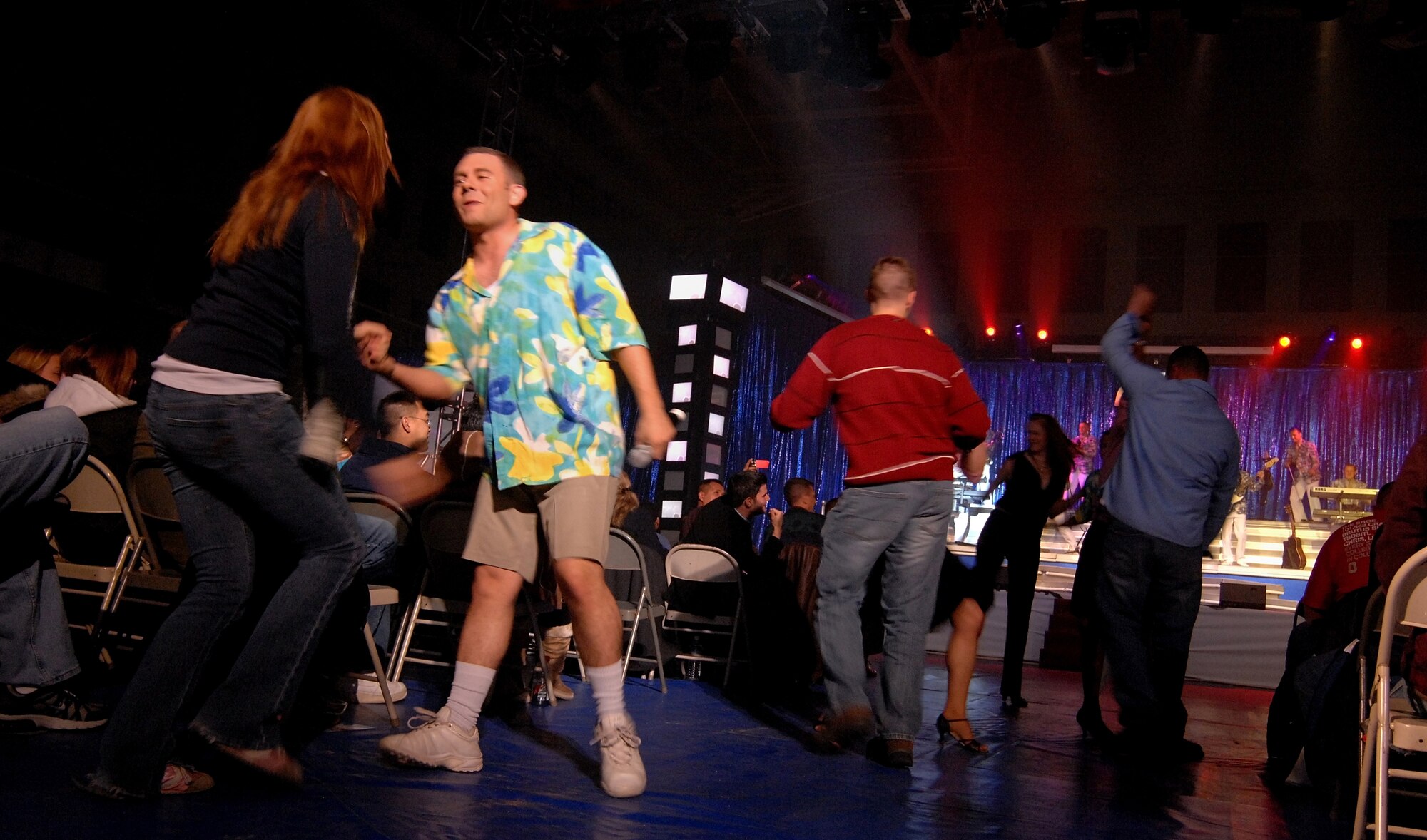 KUNSAN AIR BASE, South Korea -- Tops In Blue performers dance with members of the audience during a show here Dec 23.  The Tops In Blue 2007 tour commemorates the 60th Anniversary of the Air Force and is entitled The Fly By. They performed hits from each decade from 1947-2007. (U.S. Air Force photo/Tech. Sgt. Quinton T. Burris)