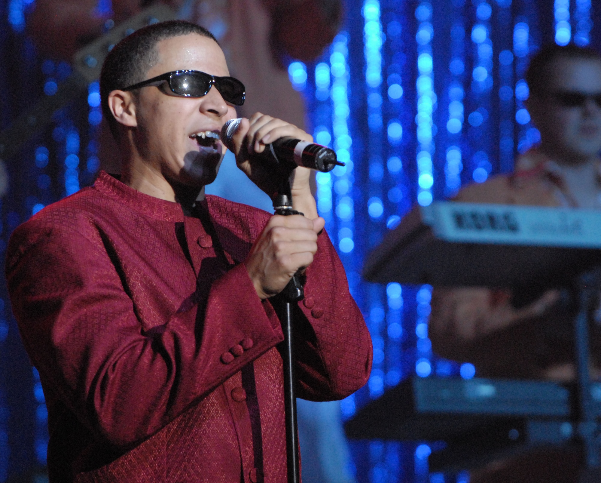 KUNSAN AIR BASE, South Korea -- Airman First Class Jesse Cox, Tops In Blue vocalist, sings a Stevie Wonder song here Dec 23.  The Tops In Blue 2007 tour commemorates the 60th Anniversary of the Air Force and is entitled The Fly By. They performed hits from each decade from 1947-2007. (U.S. Air Force photo/Senior Airman Steven R. Doty)