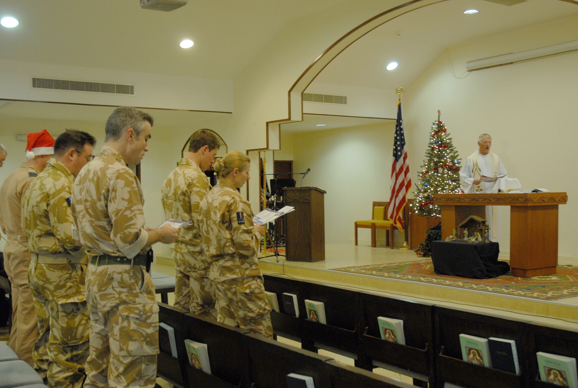 SOUTHWEST ASIA - Royal Air Force Padre Andrew Turner, No. 901 Expeditionary Air Wing, conducts a Church of England Christmas service at Victory Chapel at a Southwest Asia air base Dec. 25. (U. S. Air Force photo by Staff Sgt. Douglas Olsen)