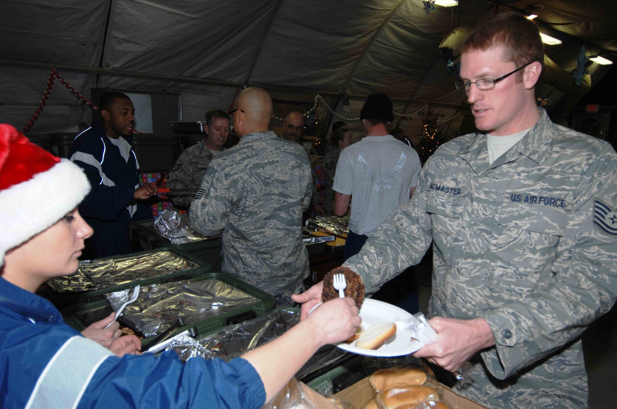 BAGRAM AIR BASE, Afghanistan - Tech. Sgt. Ryan McMaster, 774th Expeditionary Airlift Squadron, enjoys a holiday meal during a celebration co-sponsored by the 455th Expeditionary Mission Support Squadron, private organizations and volunteers, Dec. 23.  (U.S. Air Force Photo by Capt. Mike Meridith)