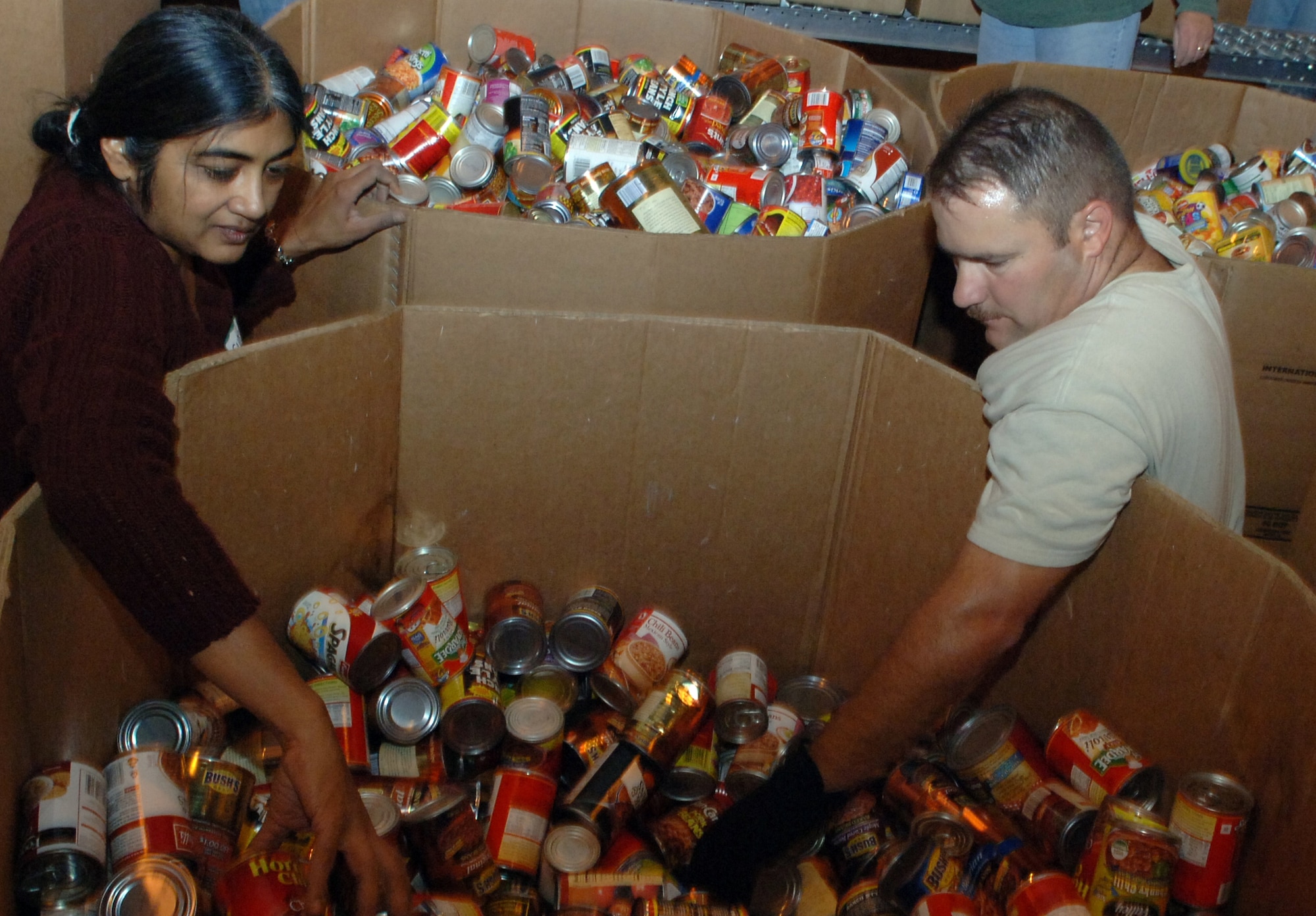 Sudha Brown (left) and Master Sgt. David Maxwell, along with 43 other Airmen
and civilians from 12th Air Force headquarters, volunteered their time
Saturday to provide service to more than 10,000 Tucson residents in need in
the local community.  The team, who schedules time each quarter for group
volunteer projects, volunteered at the Tucson Community Food Bank, a local
charity striving to reduce the impact of hunger and chronic malnutrition
through programs of advocacy and nutrition education.
