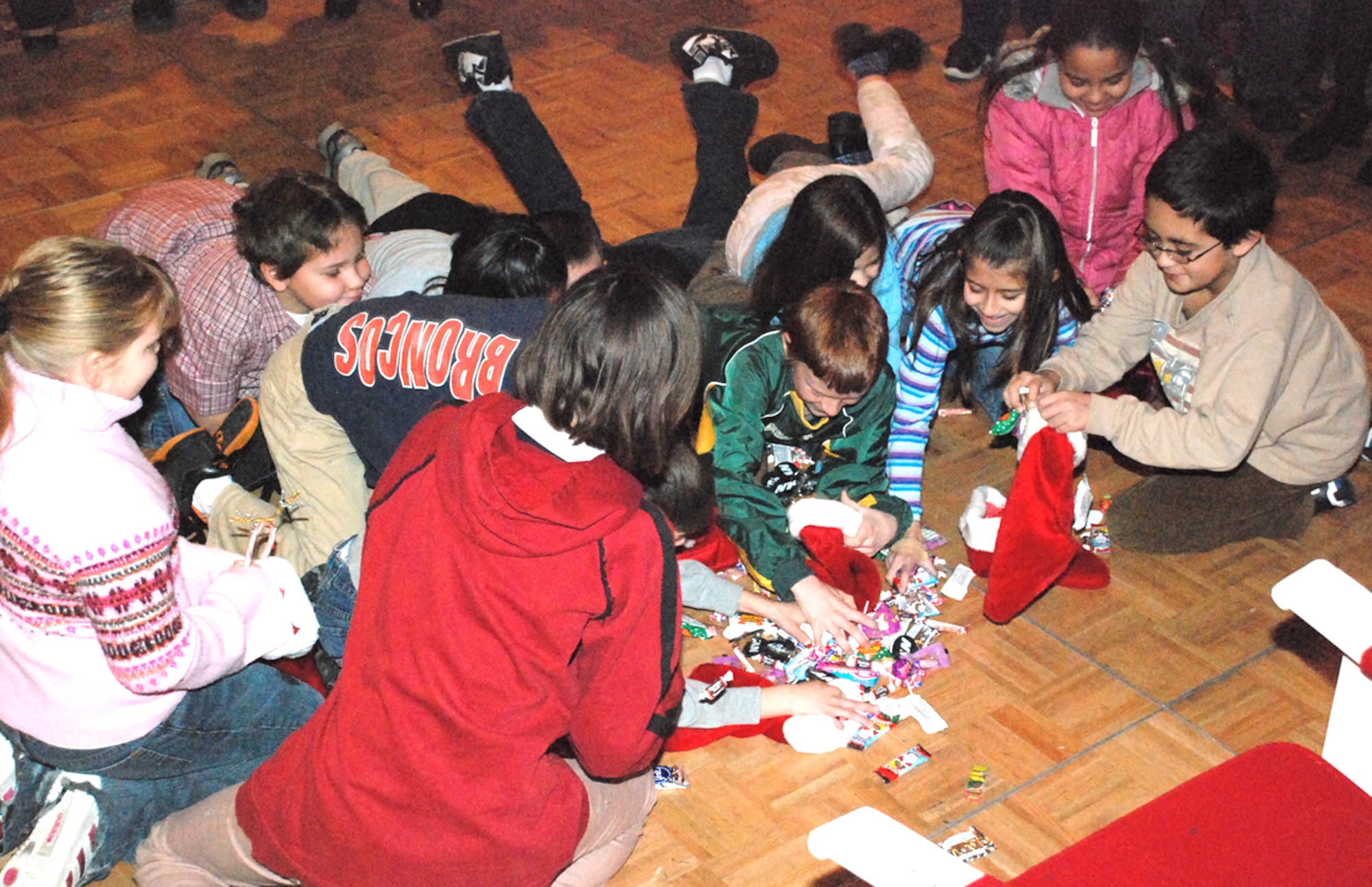 Children scramble to fill their stockings with candy during one of the games available at OPJ.