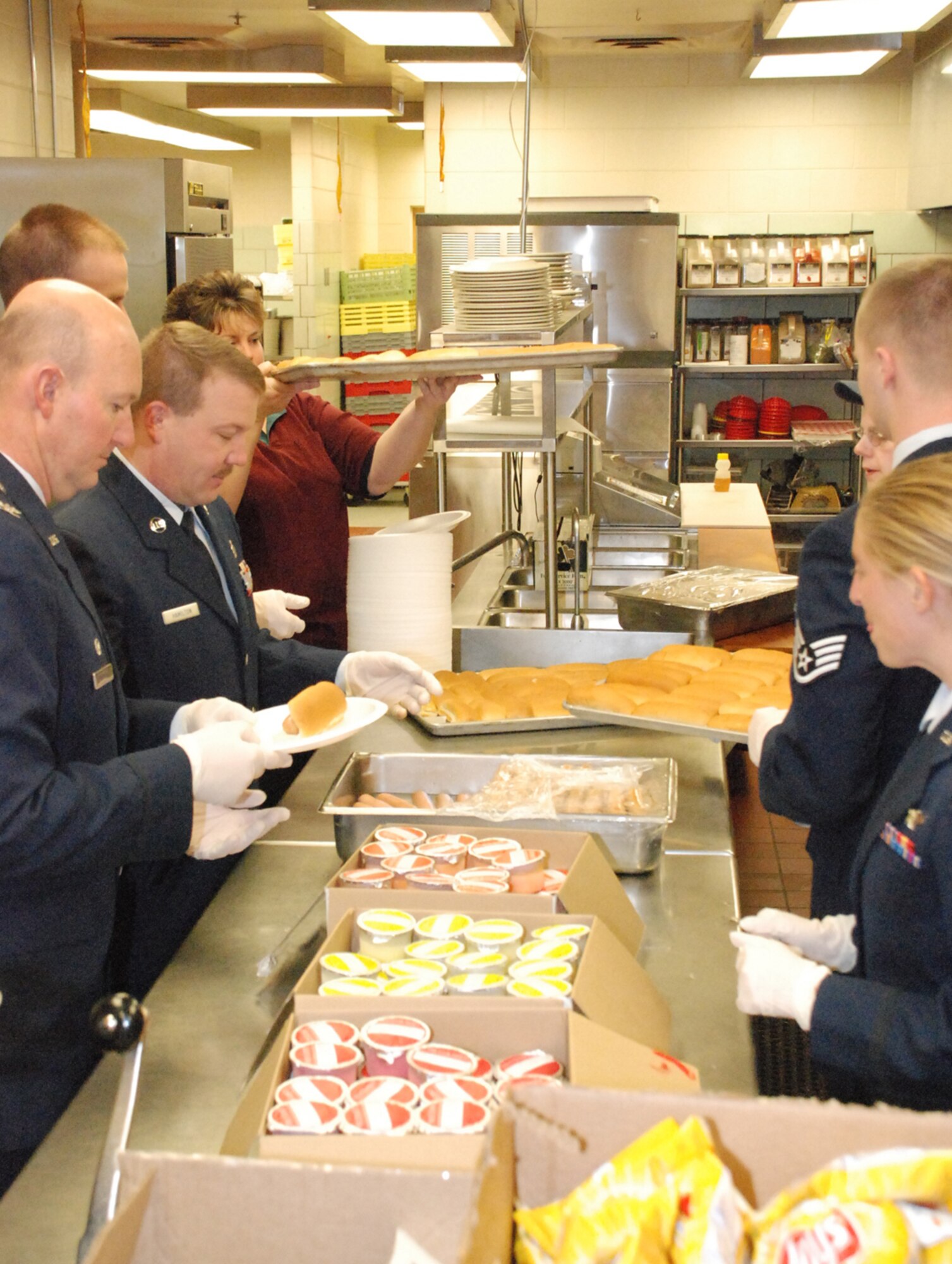 Col. Bryant Anderson, 90th Operations Group commander, and other volunteers help prepare lunch during the event.
