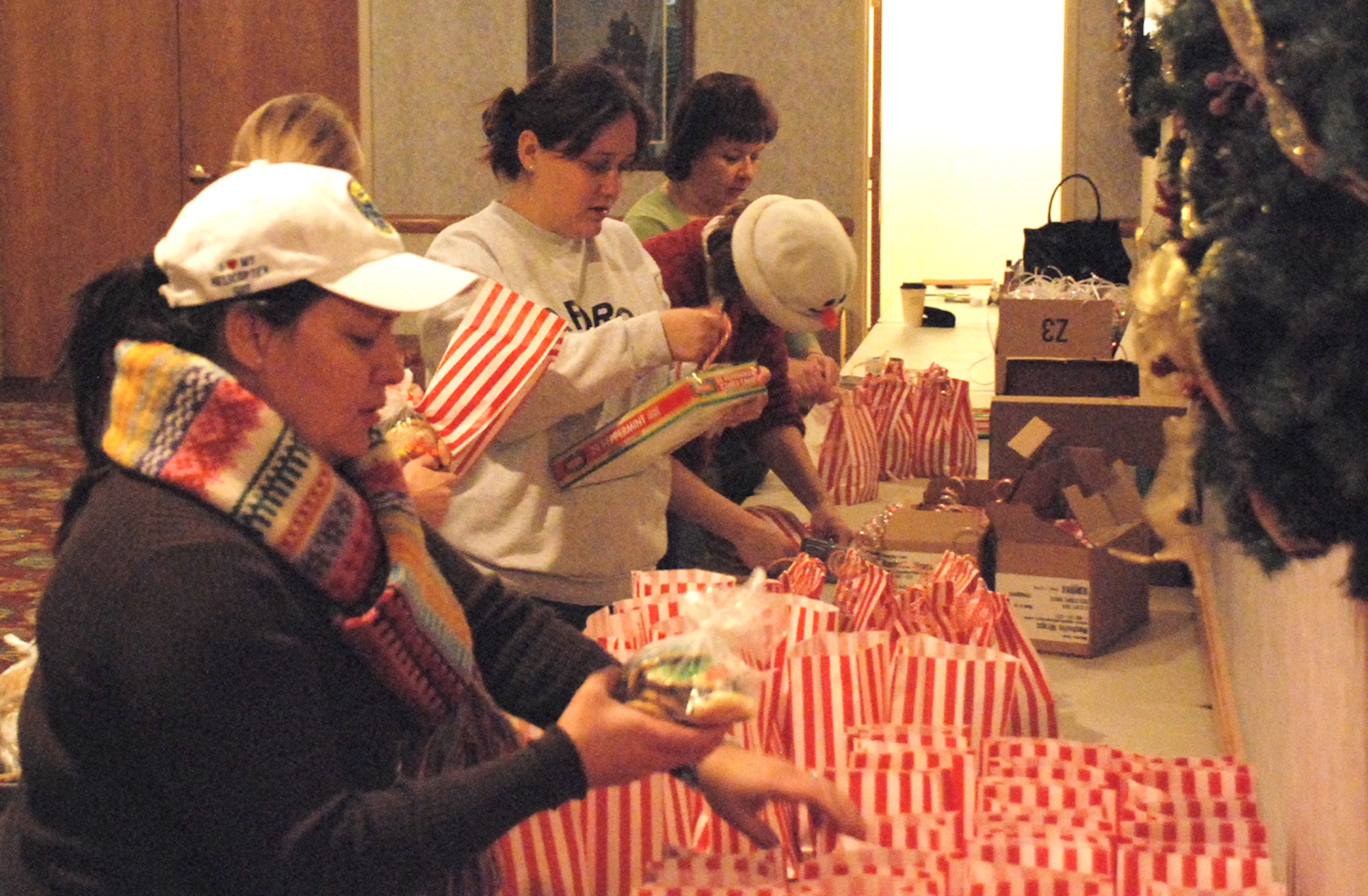 Volunteers from the Warren’s Spouses club fill more than 600 bags with cookies at the Trail’s End club Dec. 11 for Airmen living in the dormitories. The cookies were baked and donated by many members of the base and local community. This is the third annual cookie launch and it was designed to bring Airmen in the dorms a little taste of the holidays (U.S. Air Force photo by Staff Sgt. Chad Thompson).