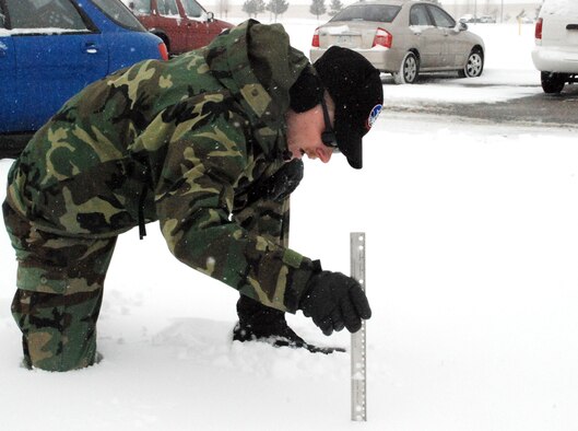 Tech. Sgt. Aaron Wesson, 90th Operations Support Squadron, measures the snow accumulation here Dec. 7. Warren had a total of six and a half inches of snow from Dec. 7 to 9 (U.S. Air Force photo by Staff Sgt. Chad Thompson).