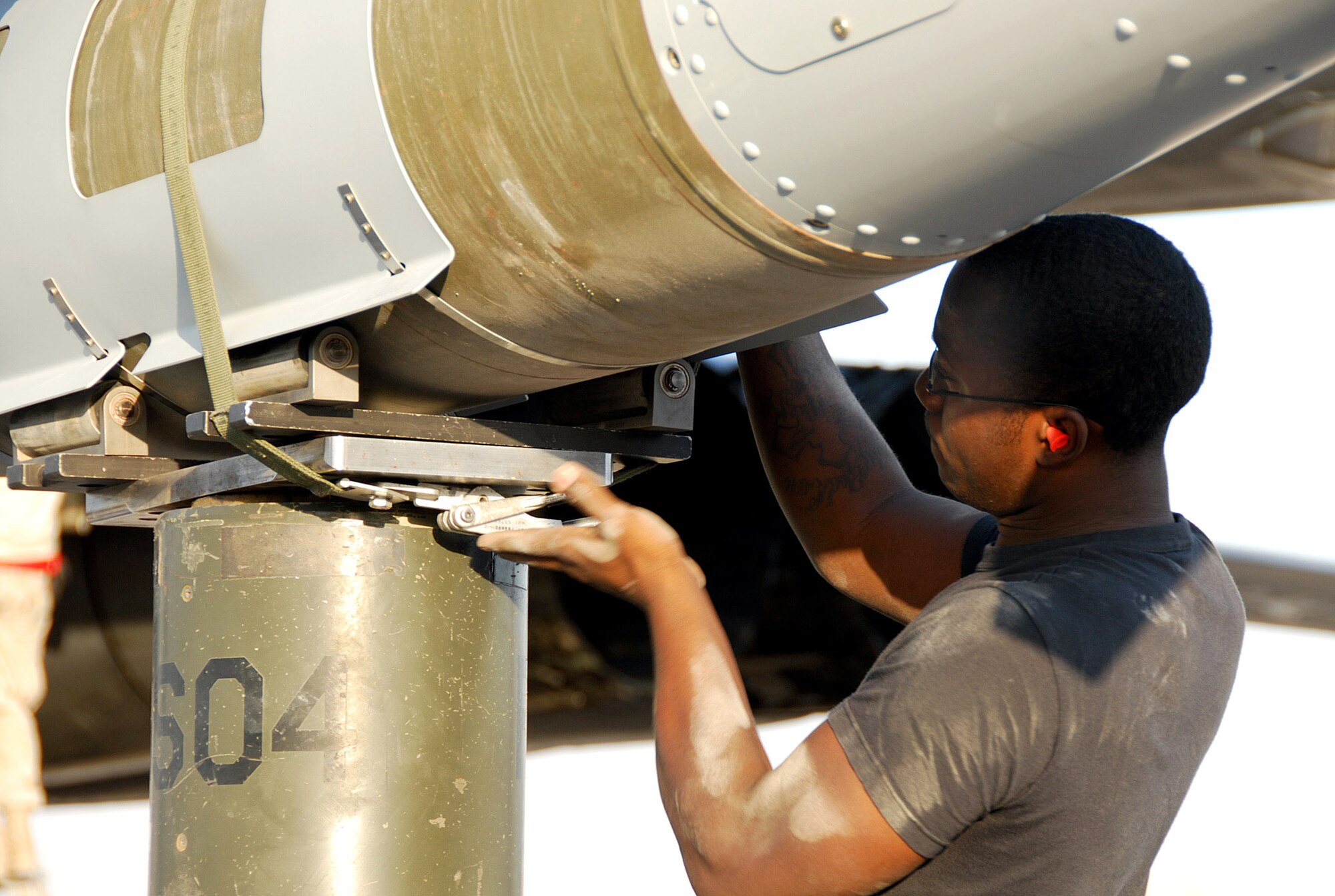 Airman 1st Class Daniel Morton secures a bomb with a strap to the ram of a ram jammer Dec. 21 at a Southwest Asia air base. Airman Morton is assigned to the 379th Expeditionary Maintenance Squadron and deployed from Dyess Air Force Base, Texas. His hometown is Anderson, S.C. (U.S. Air Force photo/Staff Sgt. Douglas Olsen) 
