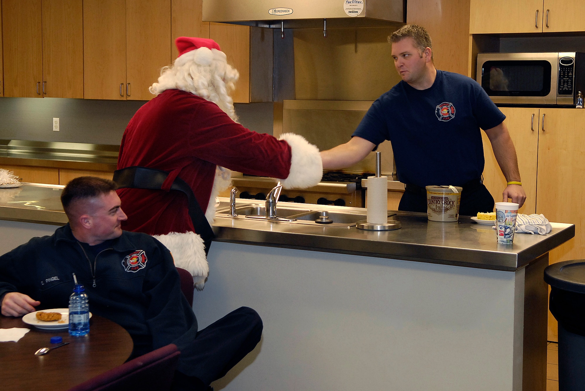 Santa Clause passes out cookies to the fire department during Buckley Air Force Base's Annual Cookie Caper Dec. 19. (U.S. Air Force photo by Senior Airman Steve Czyz)