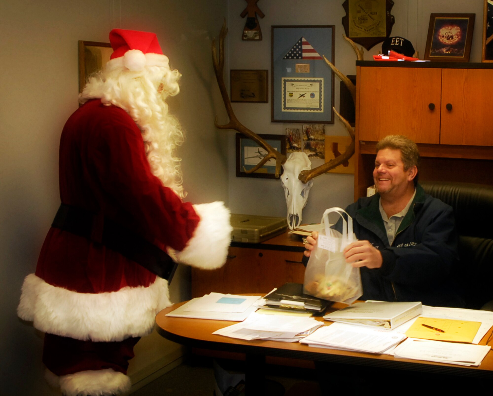 Santa Clause passes out cookies to work areas on Buckley Air Force Base during the annual Cookie Caper Dec. 19. (U.S. Air Force photo by Senior Airman Steve Czyz)