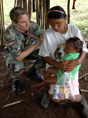 Capt. Michelle Sredinski listens to the breathing of a native Costa Rican woman at a makeshift clinic Dec. 19 at Piedra Mesa, Costa Rica. Captain Sredinski is assigned to the Joint Task Force-Bravo medical element. JTF-Bravo deployed 28 servicemembers from Soto Cano Air Base, Honduras, to Costa Rica at the invitation of the country's ministry of health for a medical readiness training exercise. (U.S. Army photo/Spc. Grant Vaught) 