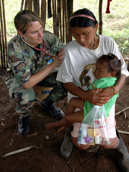 Capt. Michelle Sredinski listens to the breathing of a native Costa Rican woman at a makeshift clinic Dec. 19 at Piedra Mesa, Costa Rica. Captain Sredinski is assigned to the Joint Task Force-Bravo medical element. JTF-Bravo deployed 28 servicemembers from Soto Cano Air Base, Honduras, to Costa Rica at the invitation of the country's ministry of health for a medical readiness training exercise. (U.S. Army photo/Spc. Grant Vaught) 