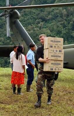 Master Sgt. Troy Himes carries boxes of food from an Army UH-60 Black Hawk helicopter to a collection point Dec. 18 at Piedra Mesa, Costa Rica. Sergeant Himes is assigned to the Joint Task Force-Bravo medical element. JTF-Bravo deployed 28 servicemembers from Soto Cano Air Base, Honduras, to Costa Rica at the invitation of the country's ministry of health for a medical readiness training exercise. (U.S. Air Force photo/Staff Sgt. Austin M. May) 