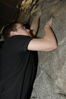 MINOT AIR FORCE BASE, N.D. -- A1C Eric Ziolecki, 91st MMXS, climbs the rock wall during a Christmas Party held at Treasure Island December 24, 2007. Treasure Island hosted the party which ran from 9 pm till midnight.