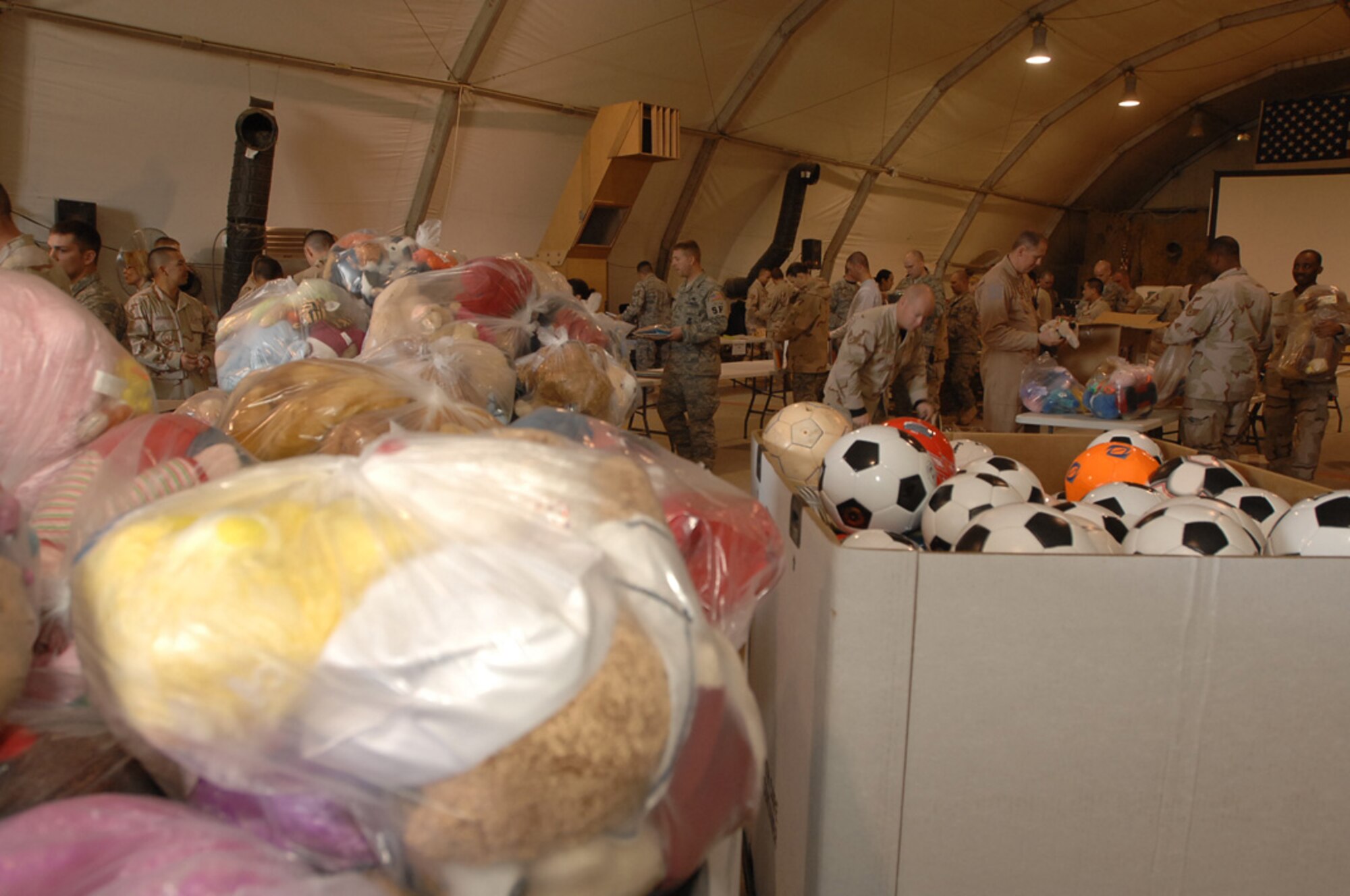ALI AIR BASE, Iraq -- After only a few hours of sorting and organizing everything, Dec. 22, over four tons of supplies are ready to be given out in support of Operation Iraqi Child led by the Focus 5/6 and Top 3 councils. In just over a month, Airmen on base collected thousands of school supply items, soccer balls, stuffed animals and toys from back home. Airmen from across all eight squadrons spent a few hours sorting all the donated items which the office of special investigations will give to Iraqi families in the An Nasiriyah area villages. (U.S. Air Force photo/Airman 1st Class Jonathan Snyder)